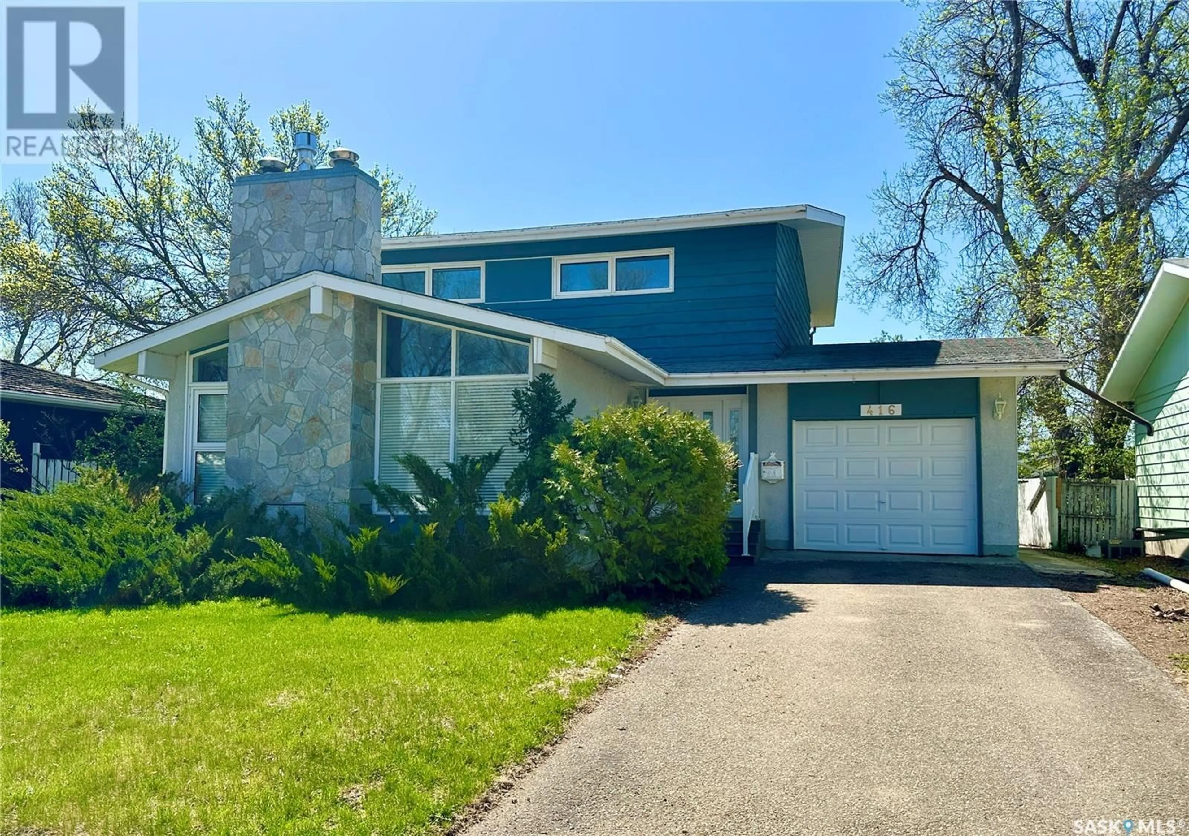 Home with vinyl exterior material, street for 416 3RD AVENUE, Weyburn Saskatchewan S4H1R1