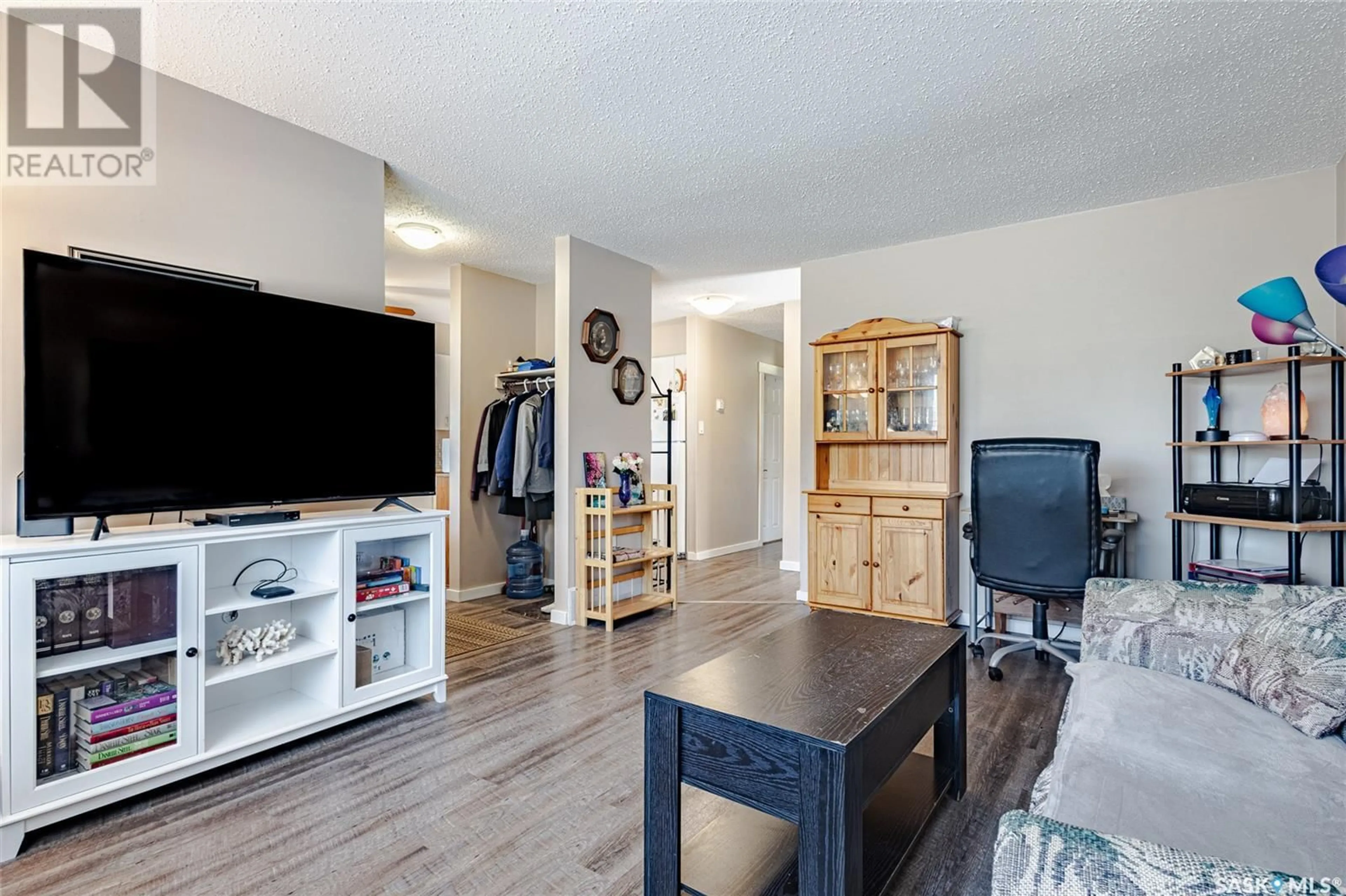 Living room with furniture, wood/laminate floor for 2709-2711 PRESTON AVENUE, Saskatoon Saskatchewan S7J2G7