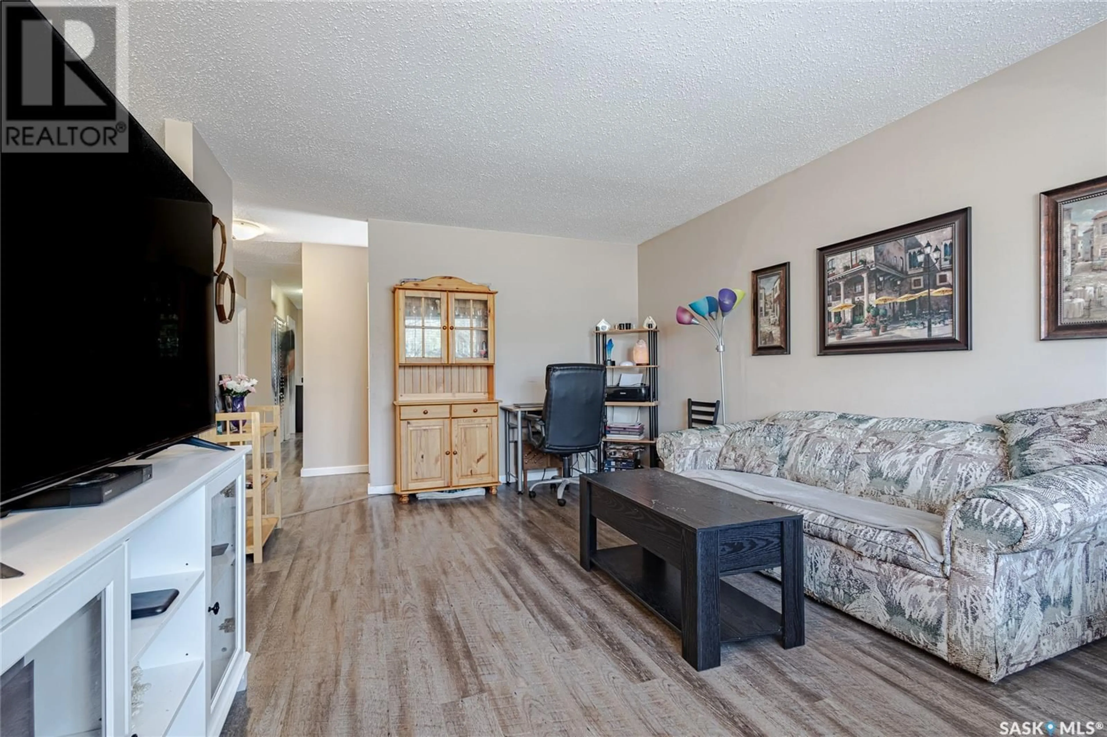 Living room with furniture, wood/laminate floor for 2709-2711 PRESTON AVENUE, Saskatoon Saskatchewan S7J2G7