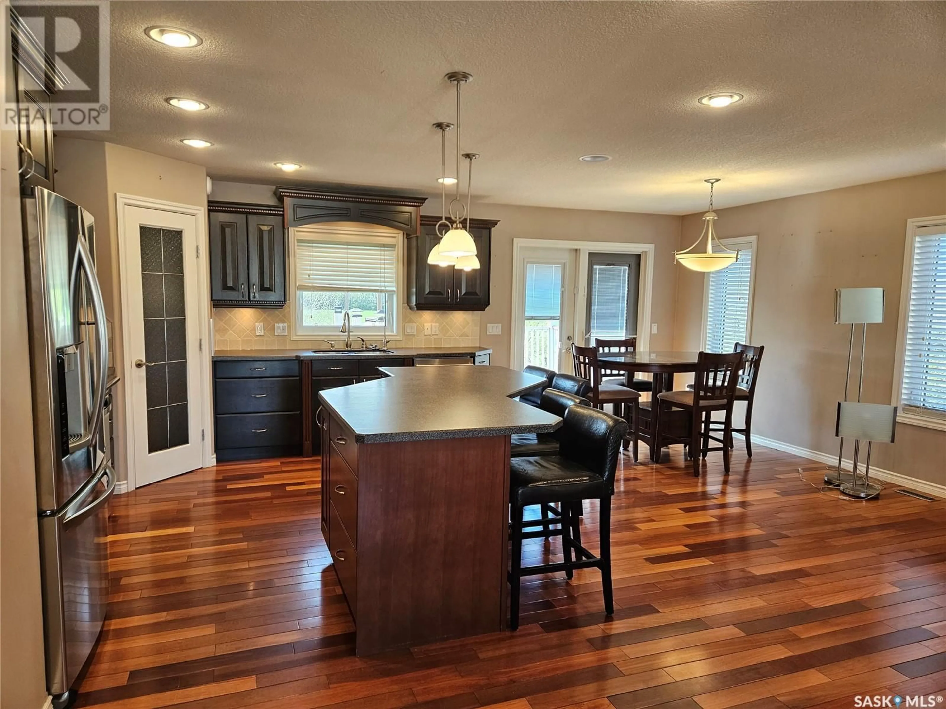 Open concept kitchen, wood/laminate floor for 5 CENTENNIAL PLACE, Carlyle Saskatchewan S0C0R0