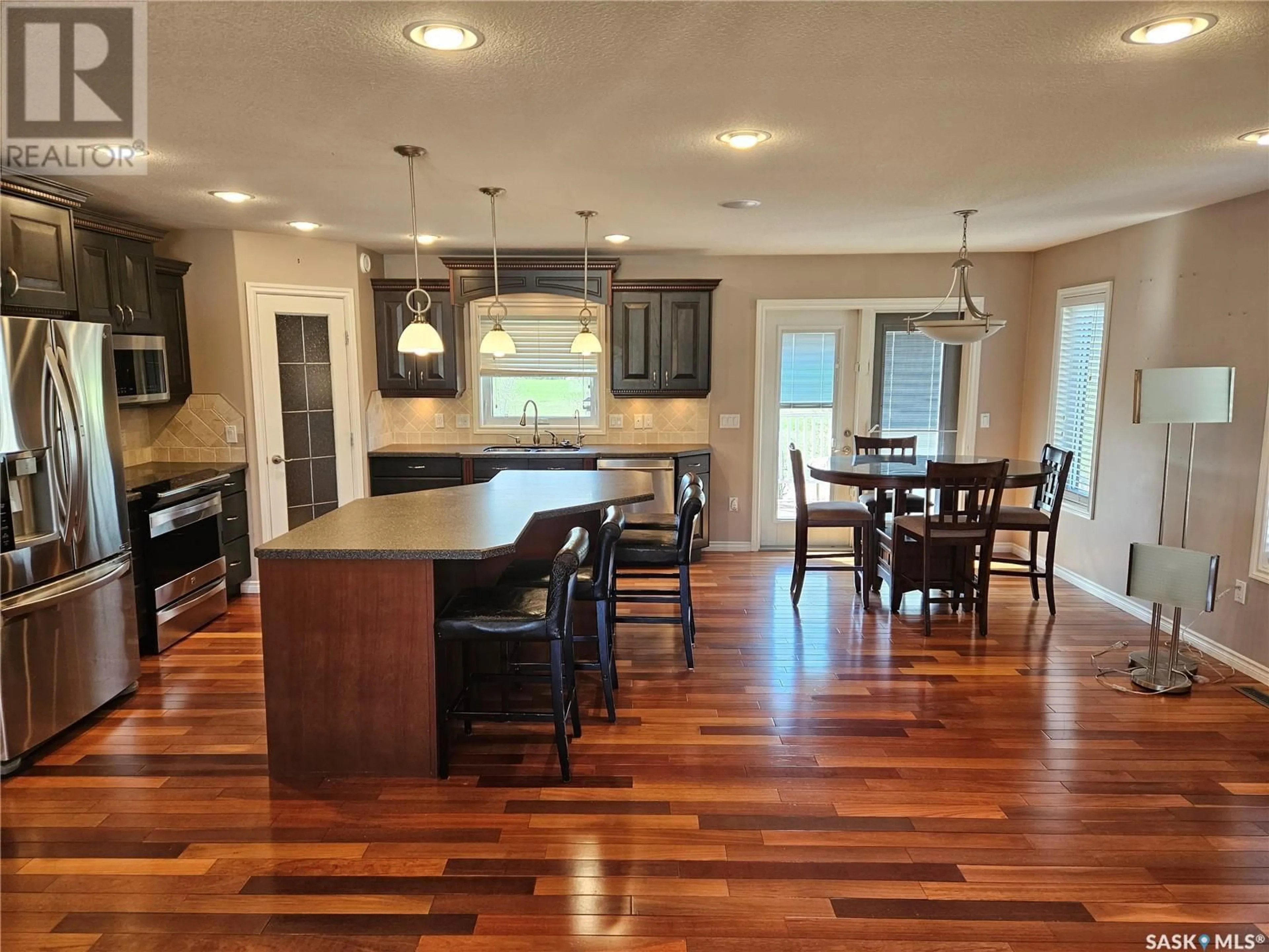 Open concept kitchen, wood/laminate floor for 5 CENTENNIAL PLACE, Carlyle Saskatchewan S0C0R0