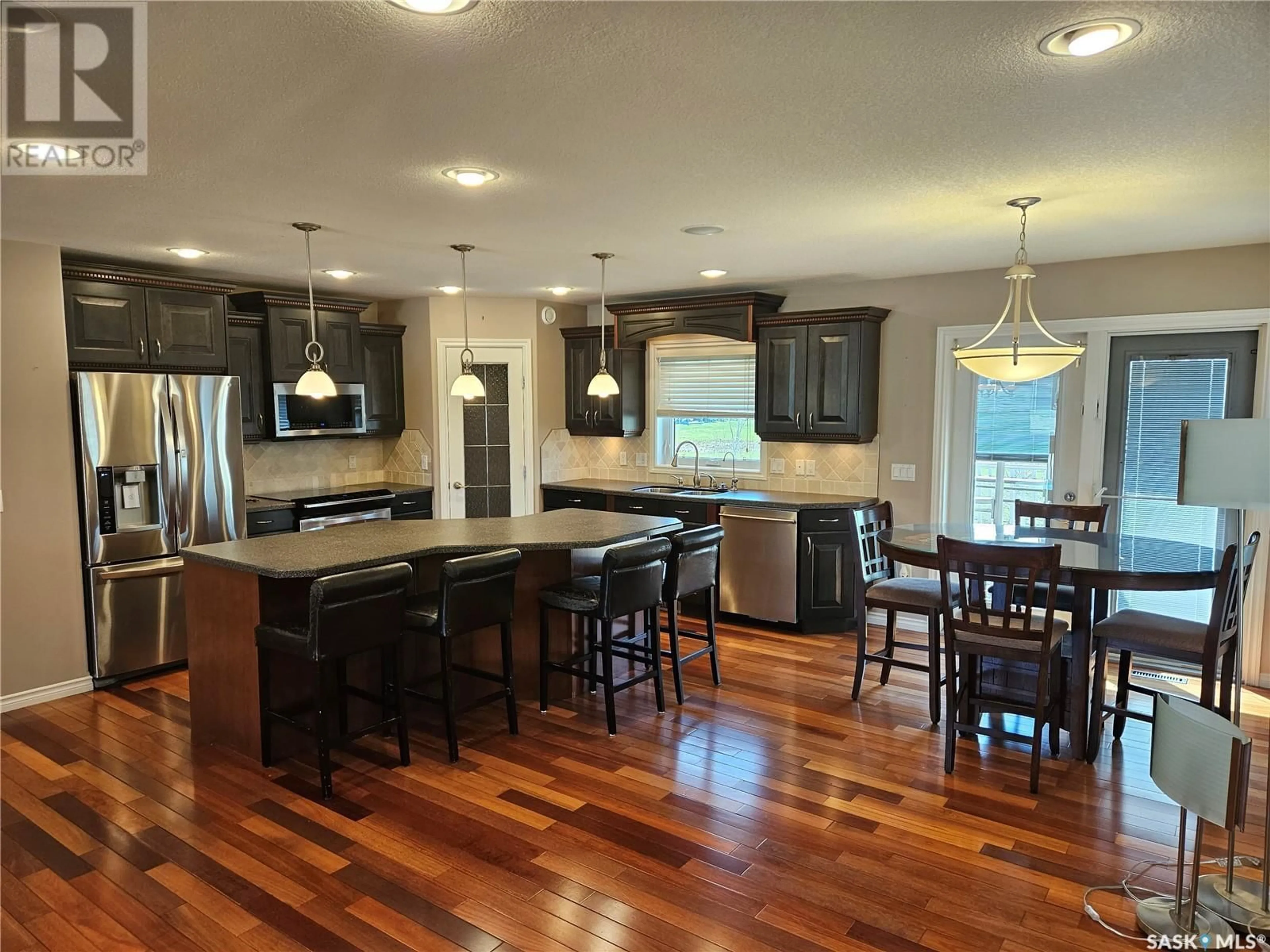 Open concept kitchen, wood/laminate floor for 5 CENTENNIAL PLACE, Carlyle Saskatchewan S0C0R0