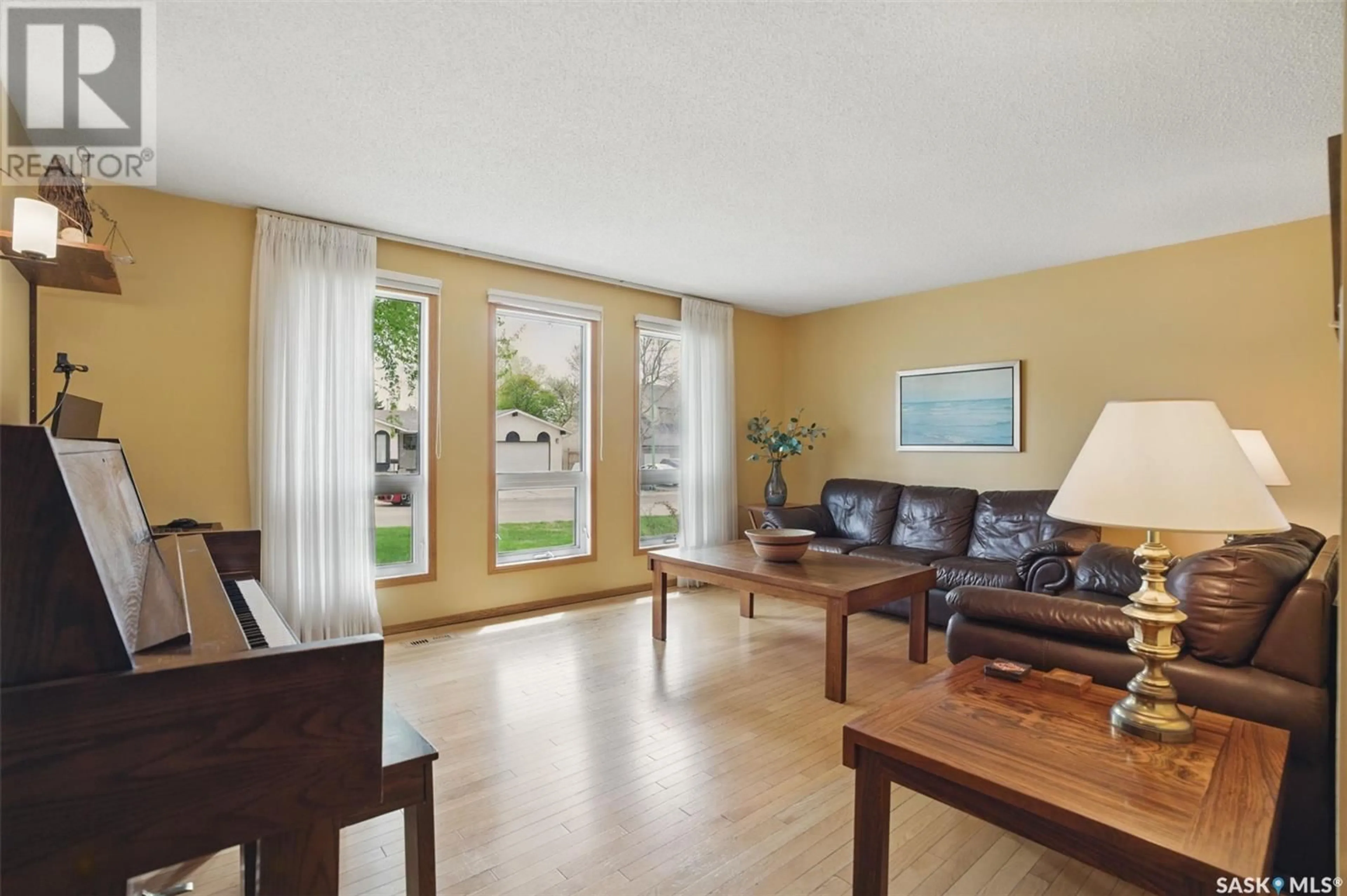 Living room with furniture, wood/laminate floor for 219 RICHARDT COURT, Saskatoon Saskatchewan S7H5B6