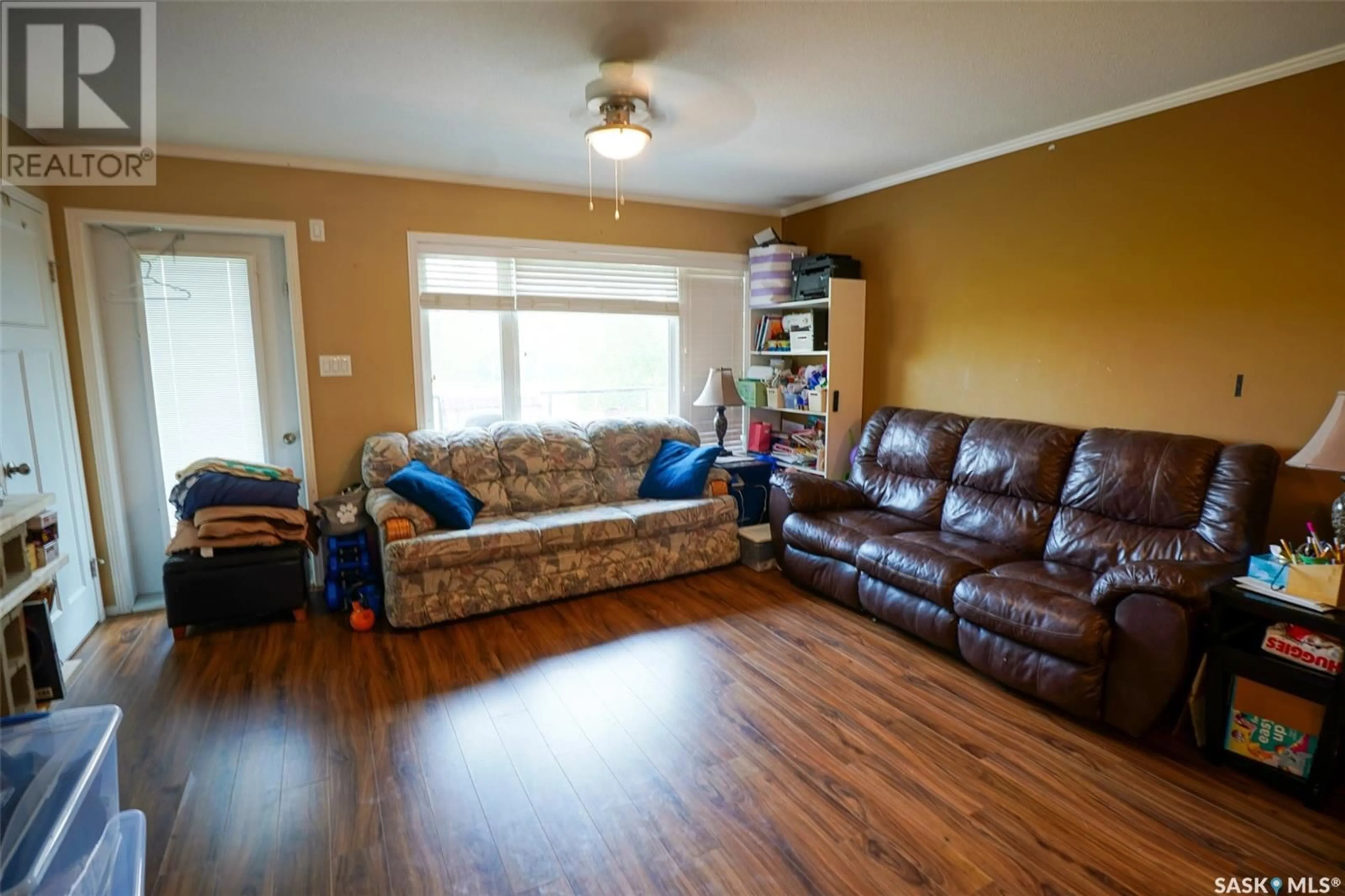 Living room with furniture, wood/laminate floor for 110 - 604 SHILLINGTON CRESCENT, Saskatoon Saskatchewan S7M3Z8