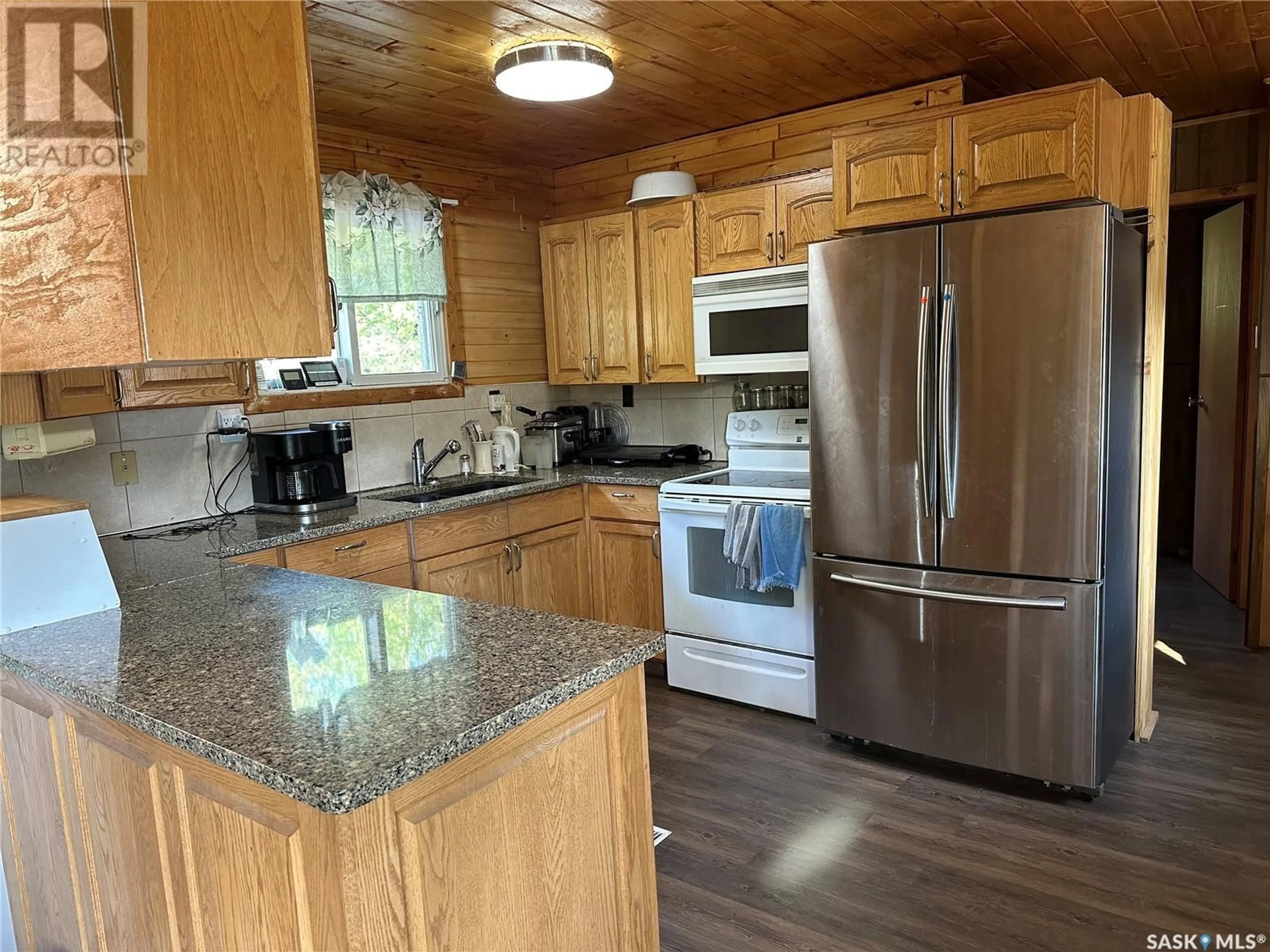 Open concept kitchen, wood/laminate floor for 409 & 509 MOGWA CRESCENT, Northern Admin District Saskatchewan S0J1L0