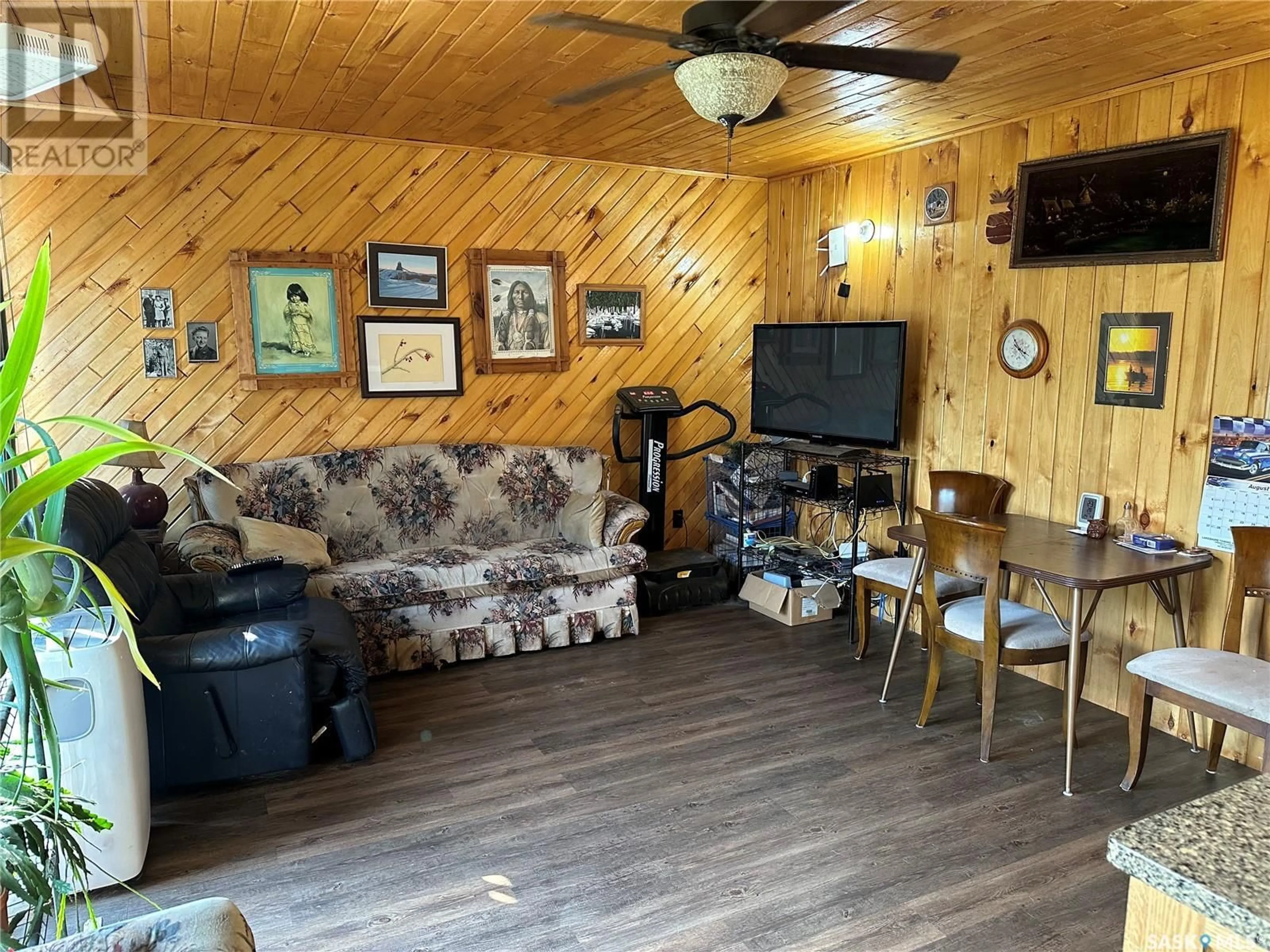 Living room with furniture, wood/laminate floor for 409 & 509 MOGWA CRESCENT, Northern Admin District Saskatchewan S0J1L0