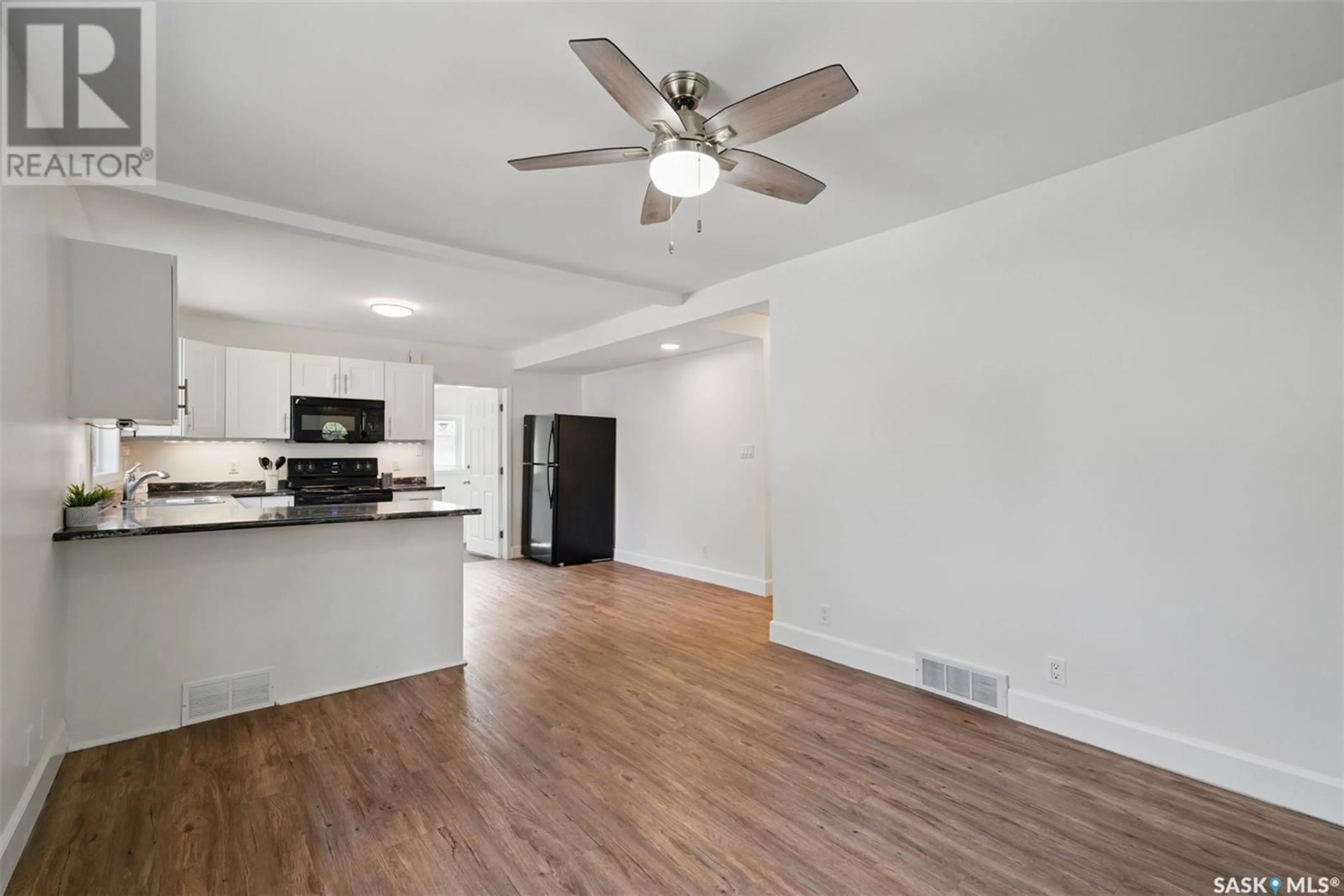 Open concept kitchen, wood/laminate floor for 730 6TH STREET, Saskatoon Saskatchewan S7H1C4
