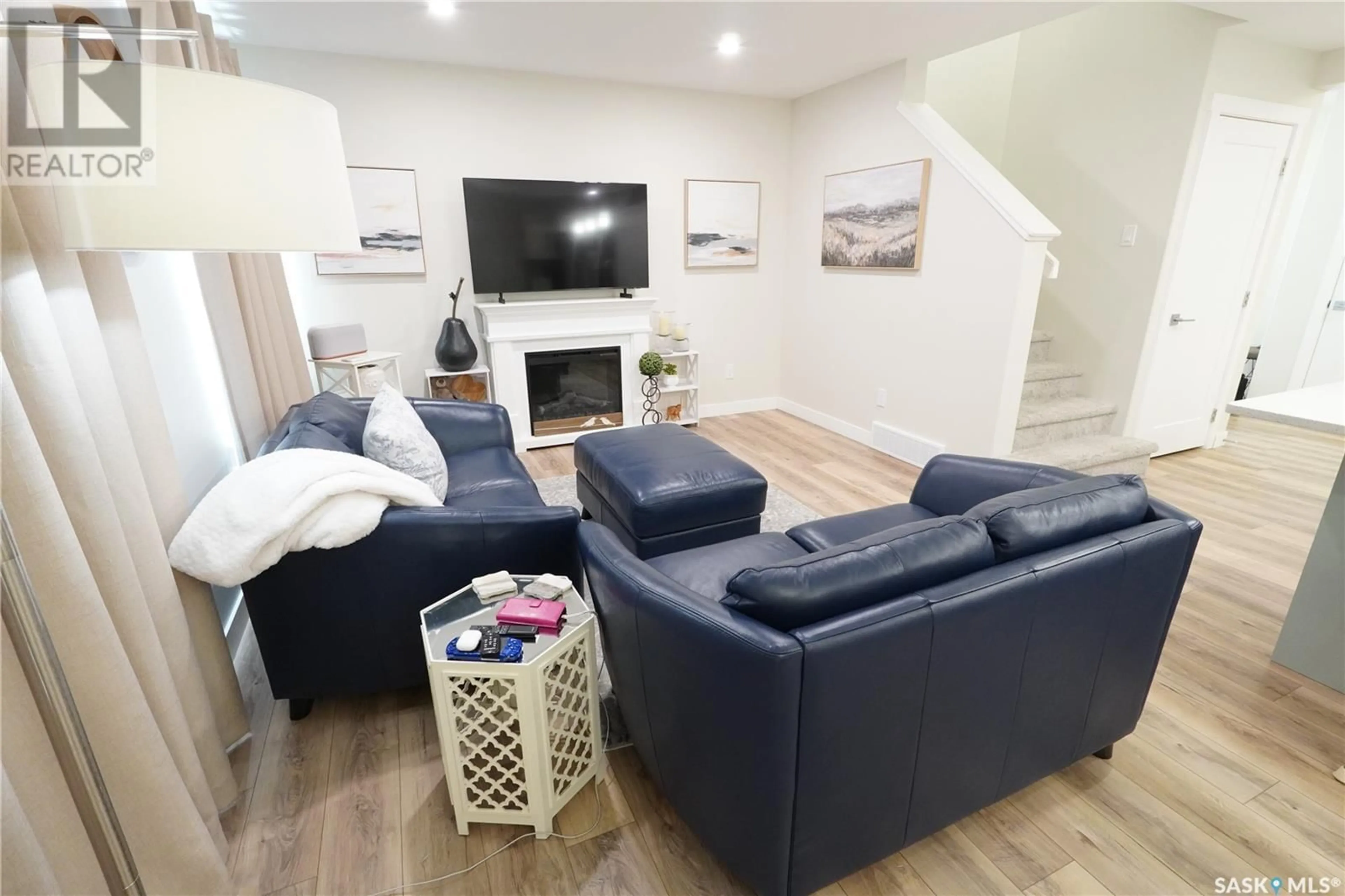 Living room with furniture, wood/laminate floor for 4665 MUTRIE CRESCENT, Regina Saskatchewan S4V3Y3