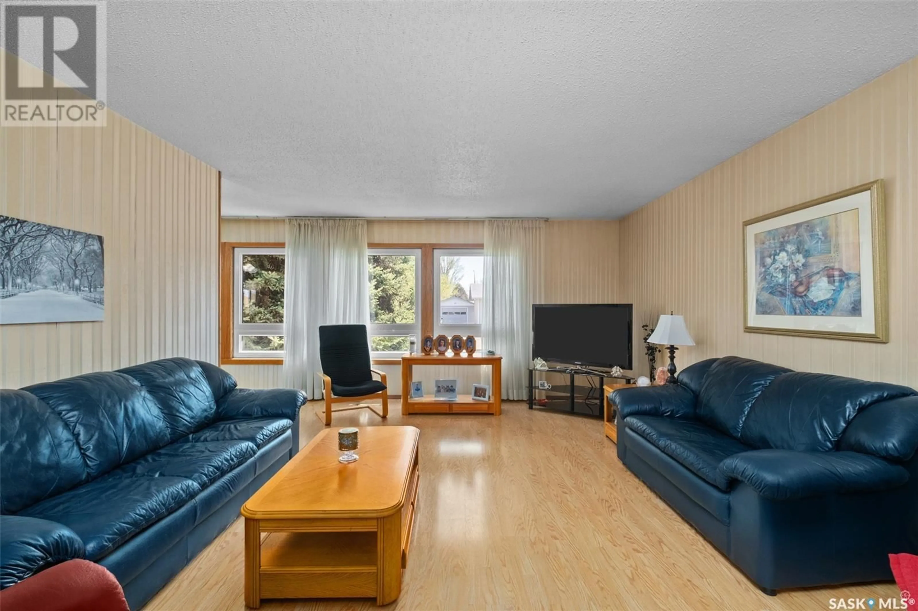 Living room with furniture, wood/laminate floor for 1306 MCKAY DRIVE, Prince Albert Saskatchewan S6V5T9