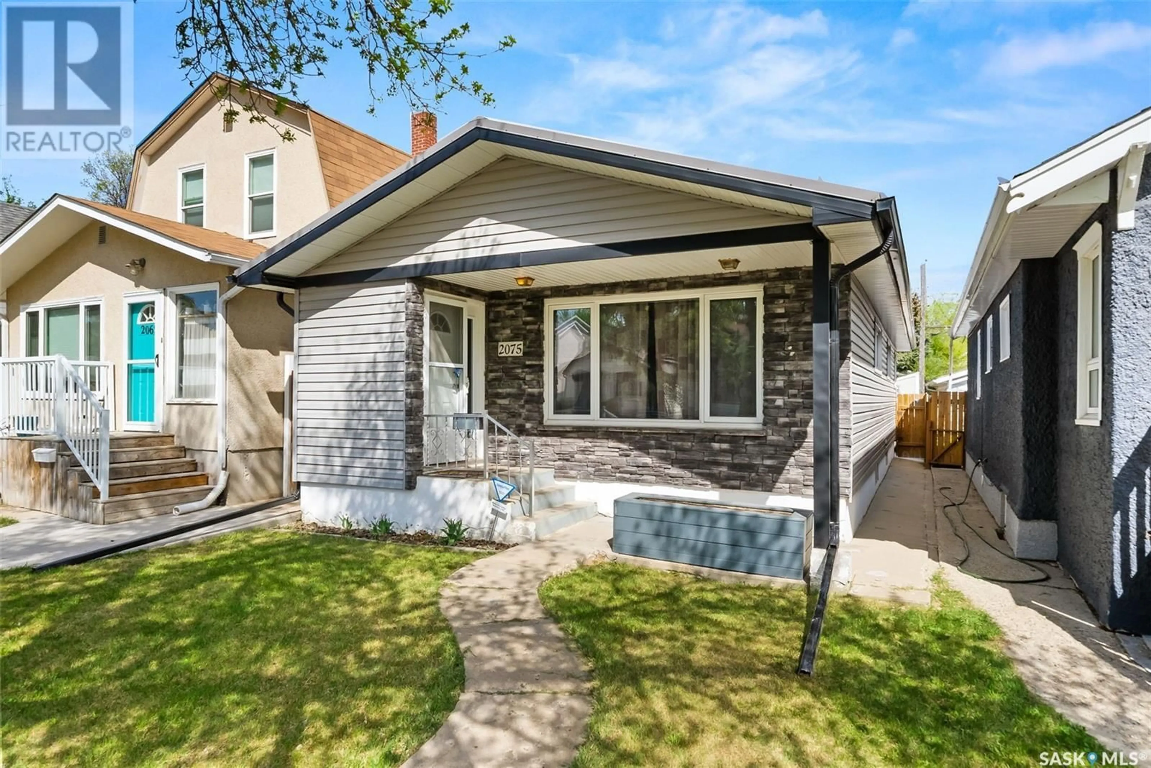 Home with brick exterior material, street for 2075 QUEEN STREET, Regina Saskatchewan S4T4C2
