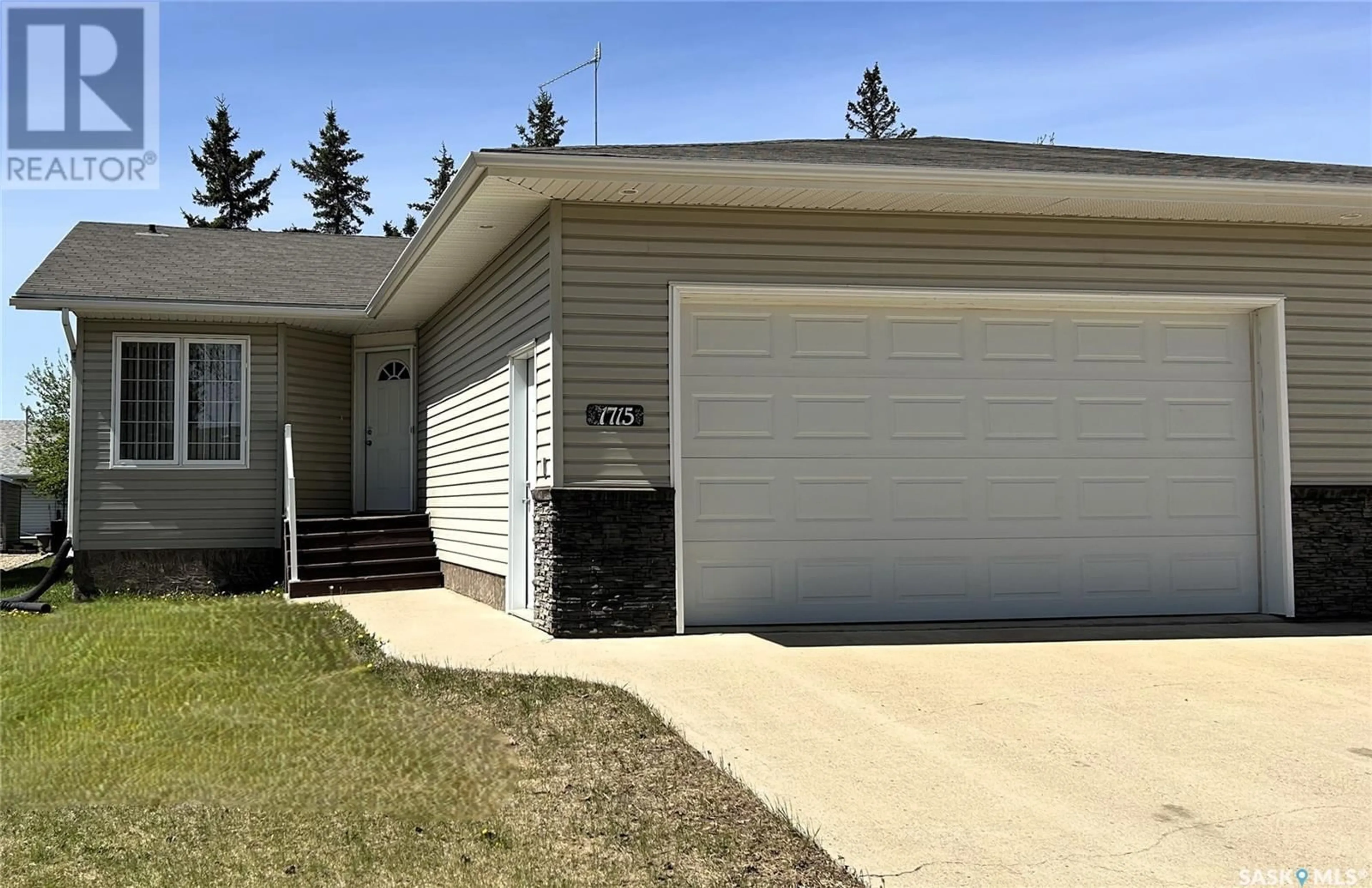 Home with vinyl exterior material, street for 1715 98TH STREET, Tisdale Saskatchewan S0E1T0