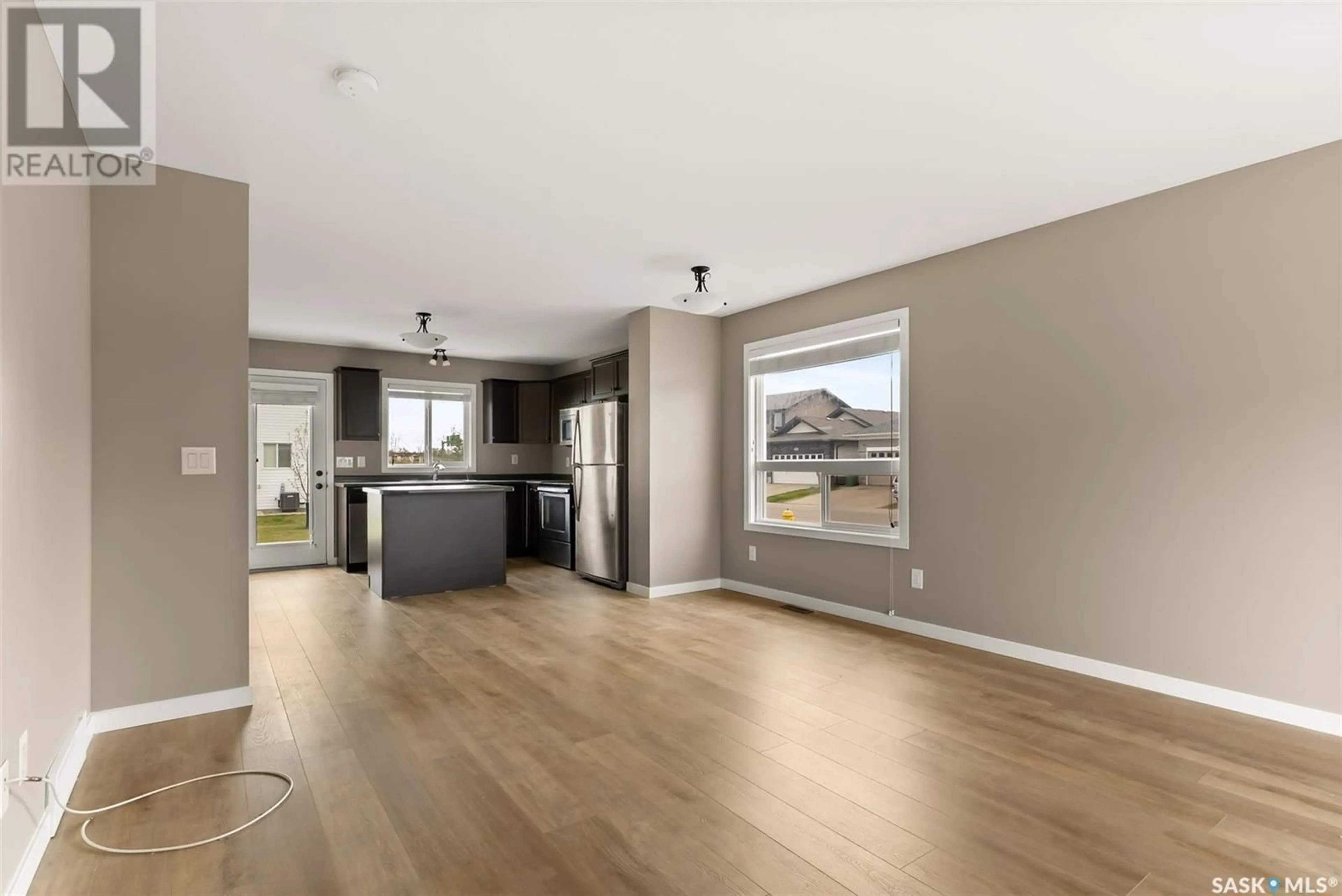 Open concept kitchen, wood/laminate floor for 68 4850 HARBOUR LANDING DRIVE, Regina Saskatchewan S4W0K9