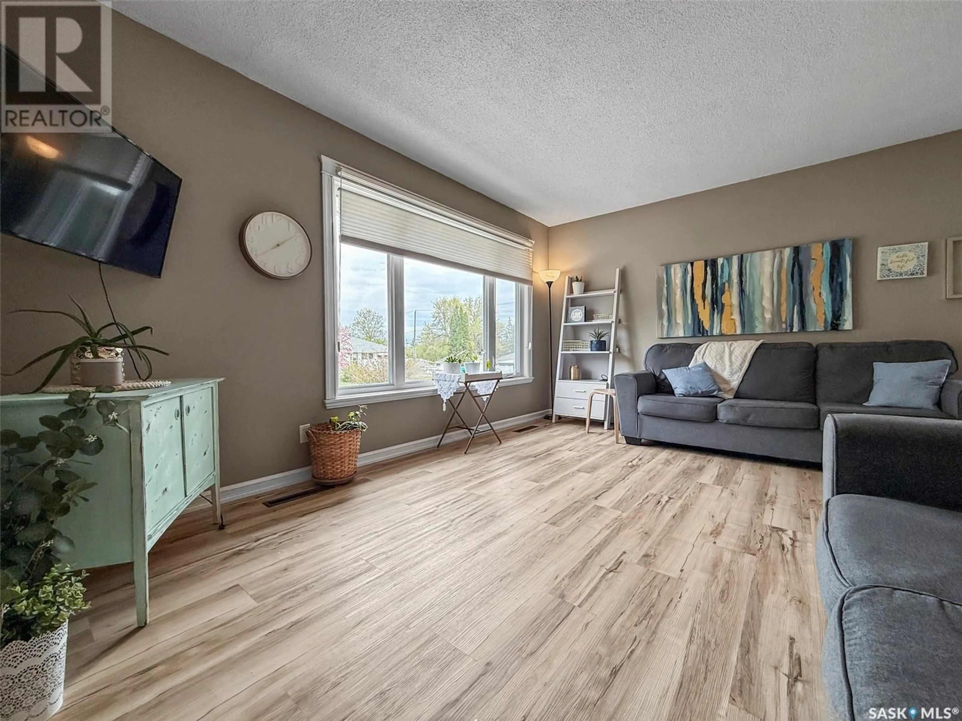 Living room with furniture, wood/laminate floor for 830 2ND AVENUE, Swift Current Saskatchewan S9H2G1
