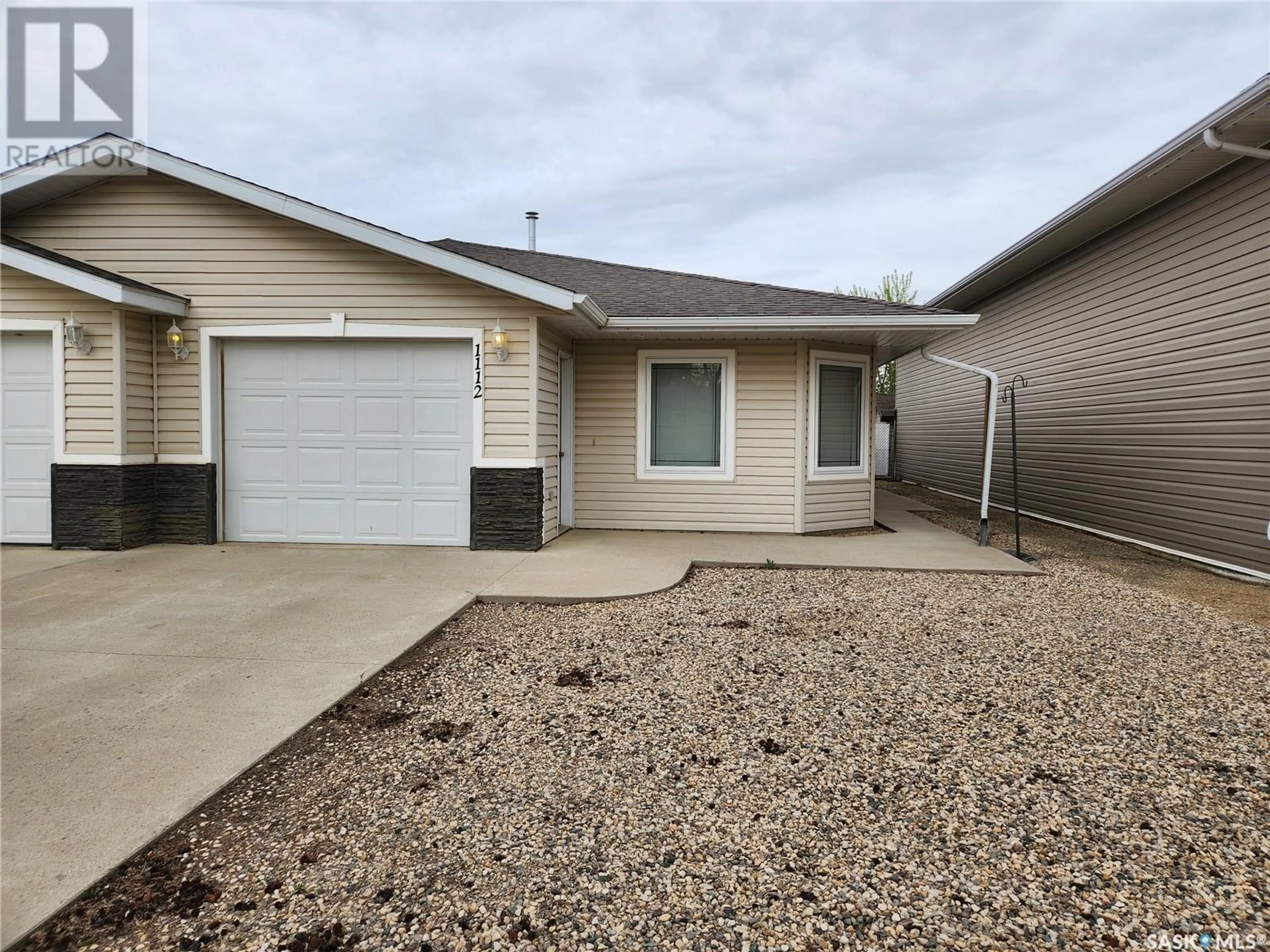 Home with vinyl exterior material, street for 1112 95TH STREET, Tisdale Saskatchewan S0E1T0