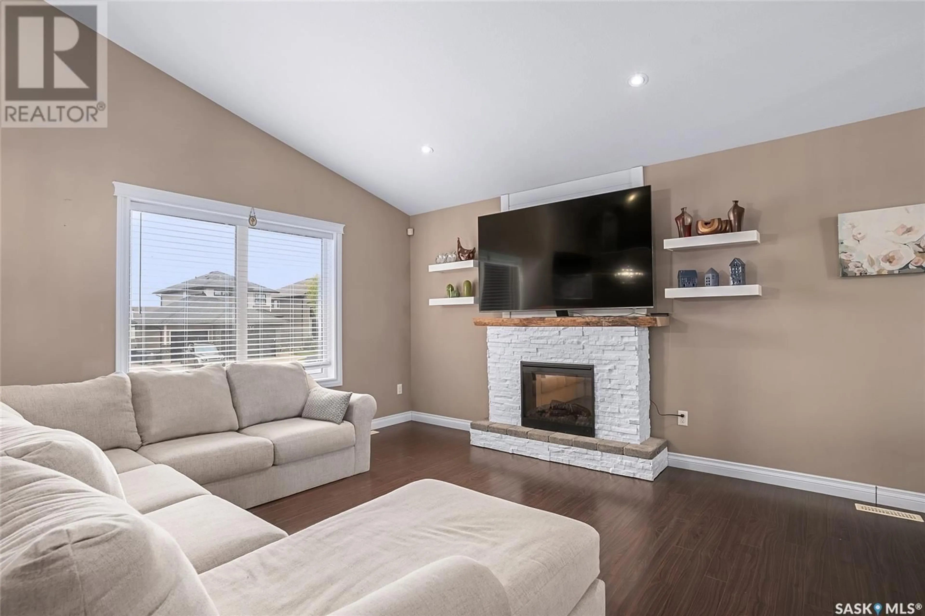 Living room with furniture, wood/laminate floor for 243 WERSCHNER CRESCENT, Saskatoon Saskatchewan S7V0E1
