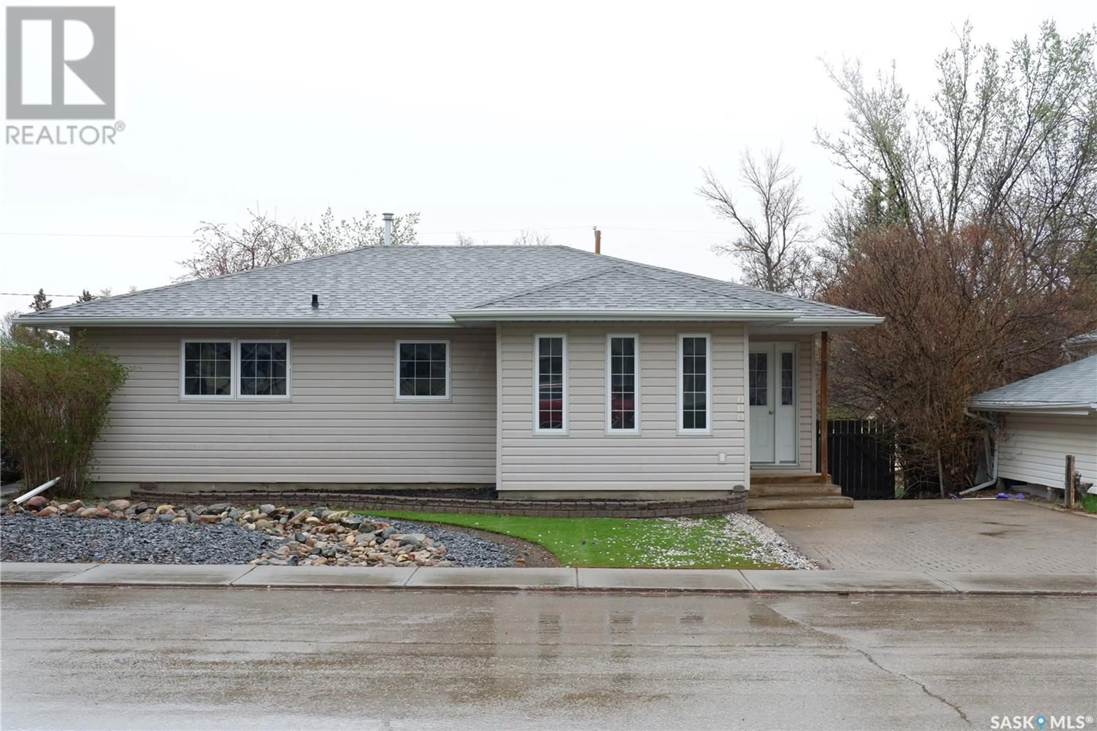 Home with vinyl exterior material, street for 216 DOMINION ROAD, Assiniboia Saskatchewan S0H0B0