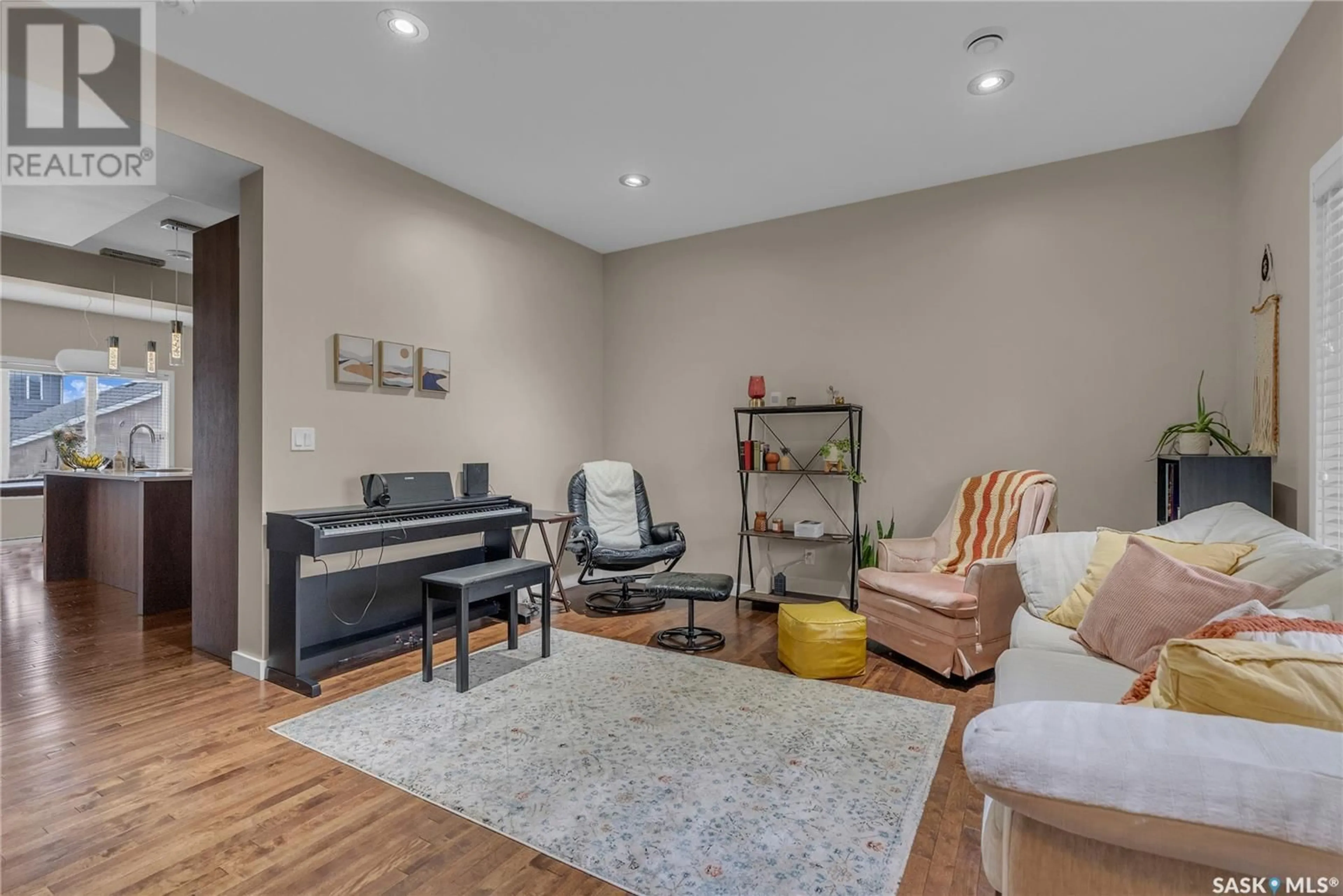 Living room with furniture, wood/laminate floor for 167 TWEED LANE, Saskatoon Saskatchewan S7V0K1