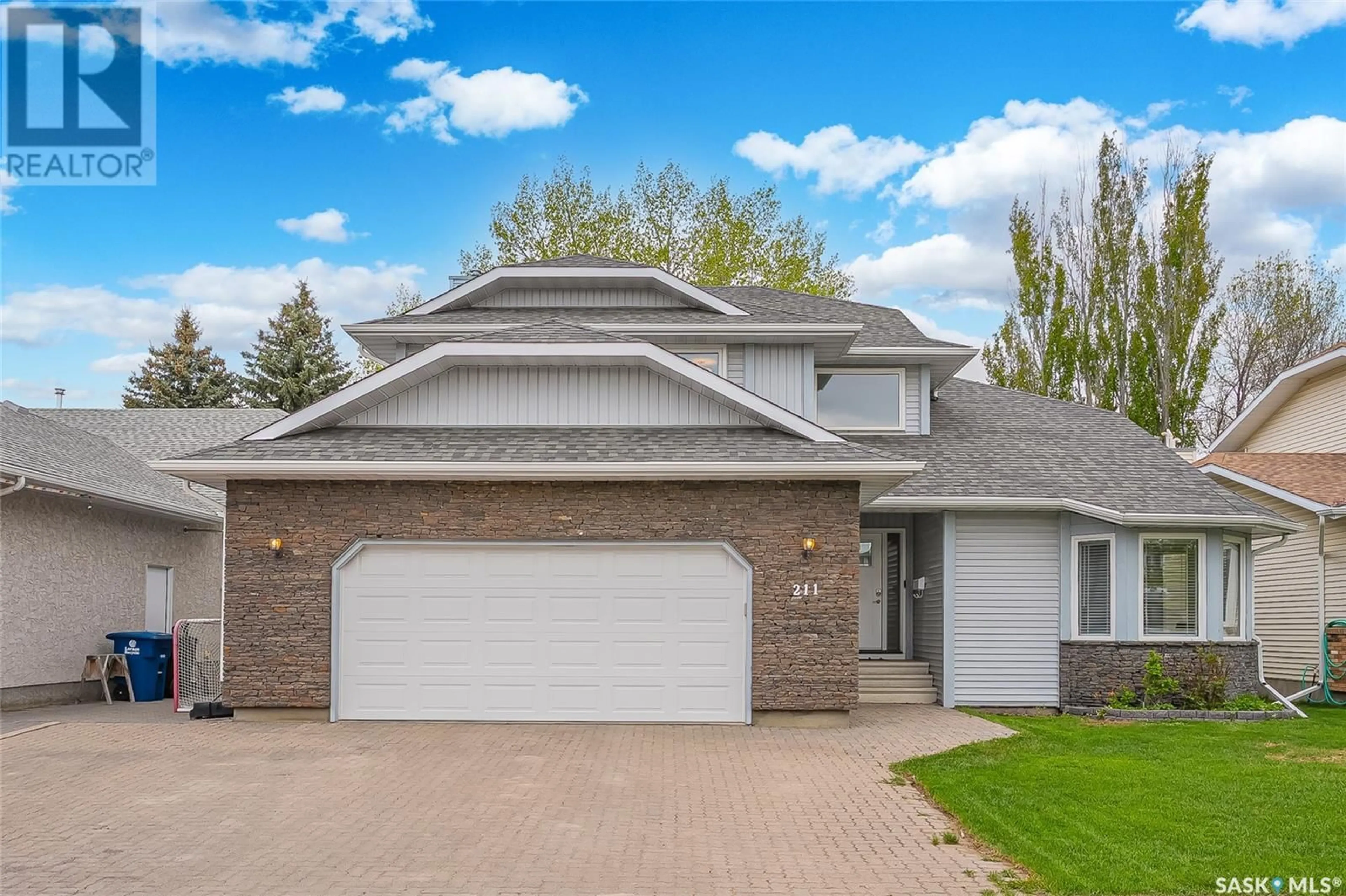 Home with vinyl exterior material, street for 211 NESSLIN TERRACE, Saskatoon Saskatchewan S7J4S2