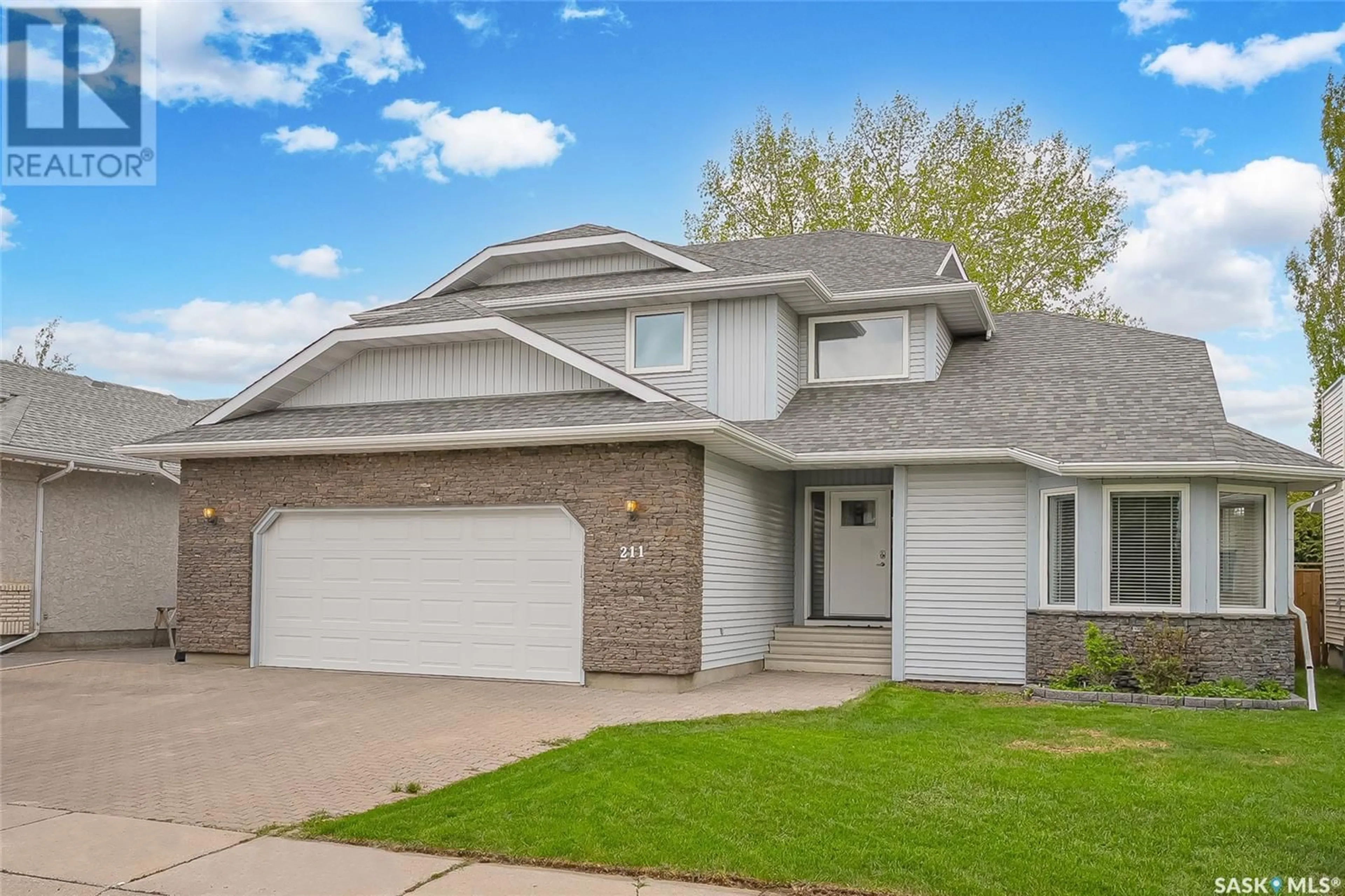 Home with vinyl exterior material, street for 211 NESSLIN TERRACE, Saskatoon Saskatchewan S7J4S2