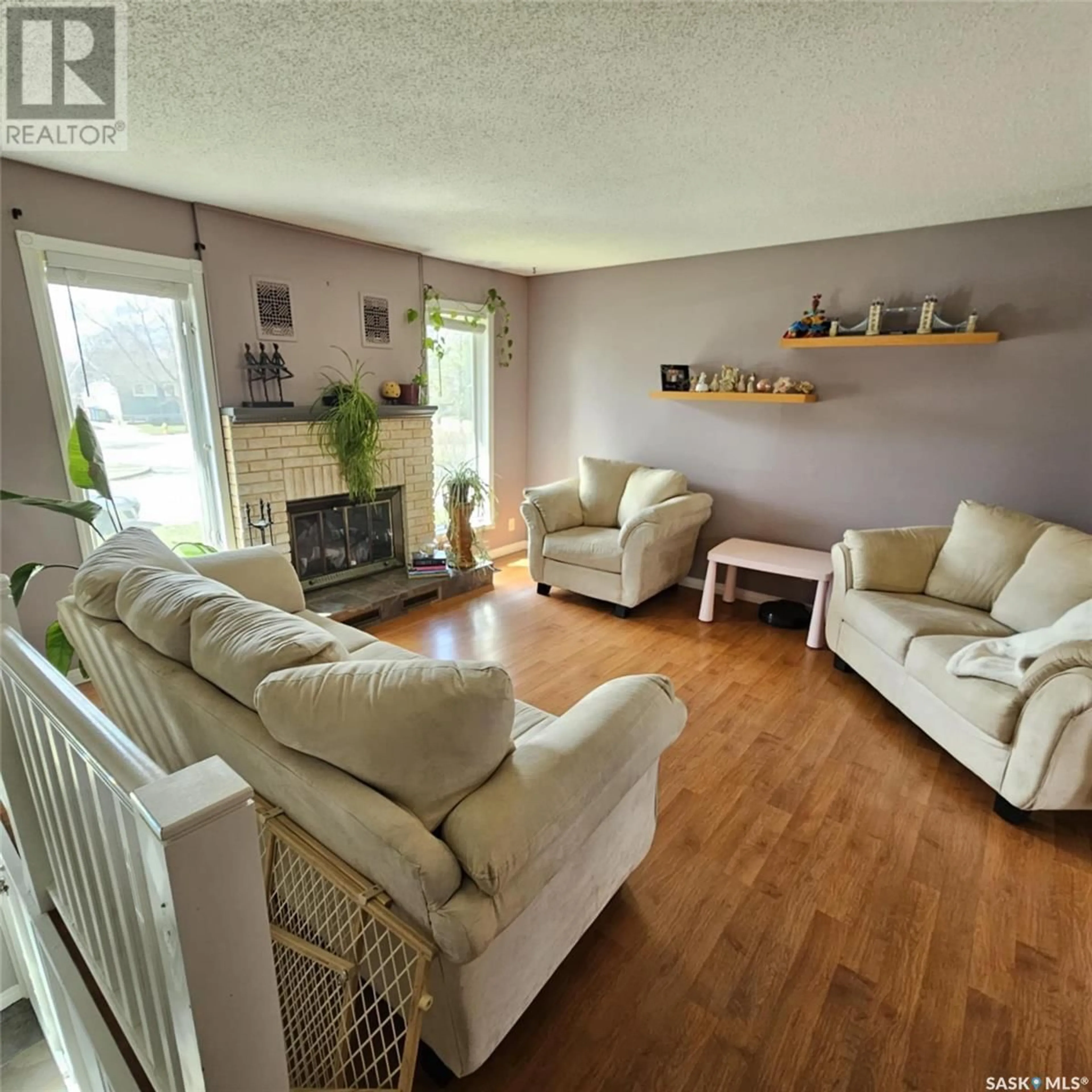 Living room with furniture, wood/laminate floor for 7058 BLAKENEY DRIVE, Regina Saskatchewan S4X2N5