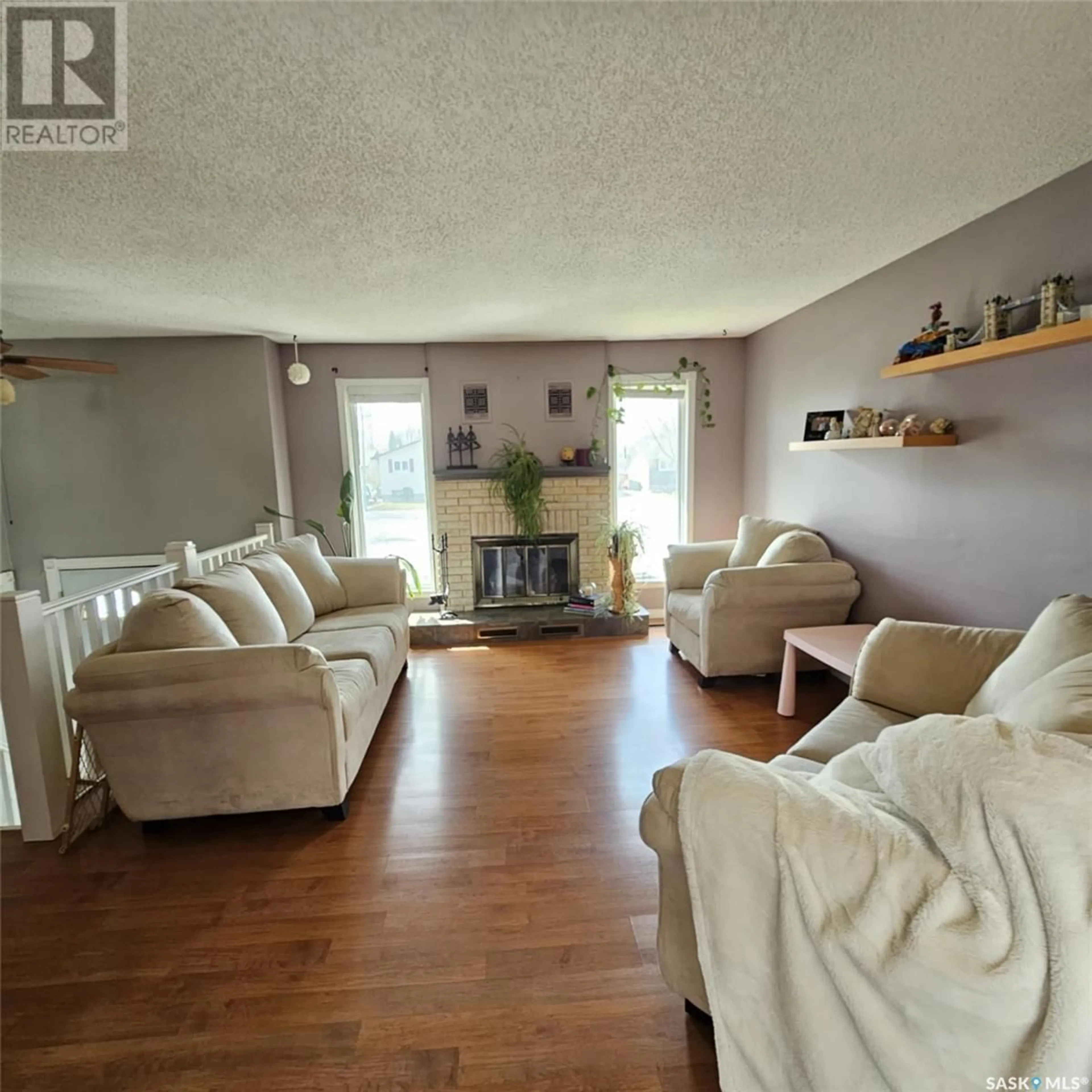 Living room with furniture, wood/laminate floor for 7058 BLAKENEY DRIVE, Regina Saskatchewan S4X2N5