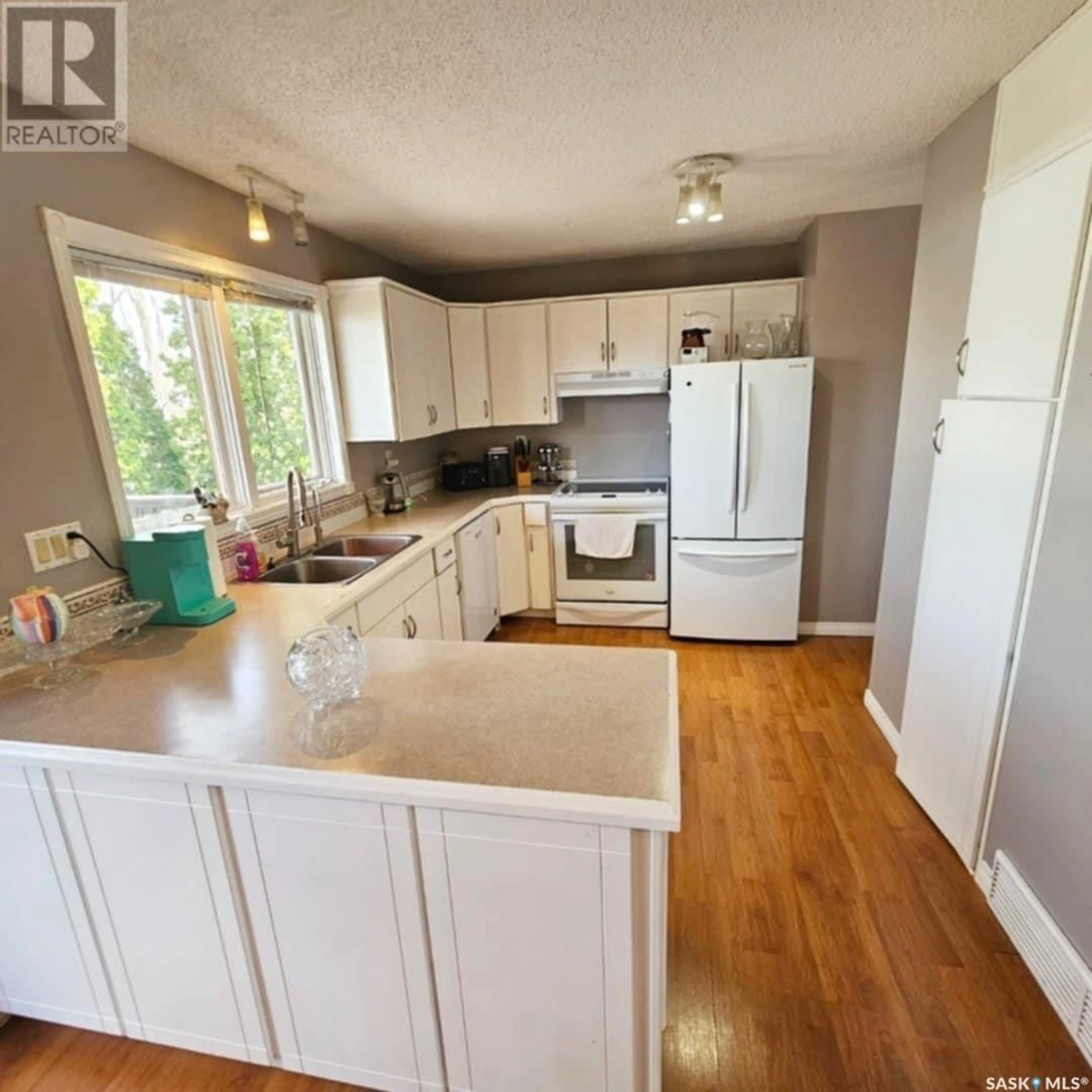Open concept kitchen, wood/laminate floor for 7058 BLAKENEY DRIVE, Regina Saskatchewan S4X2N5