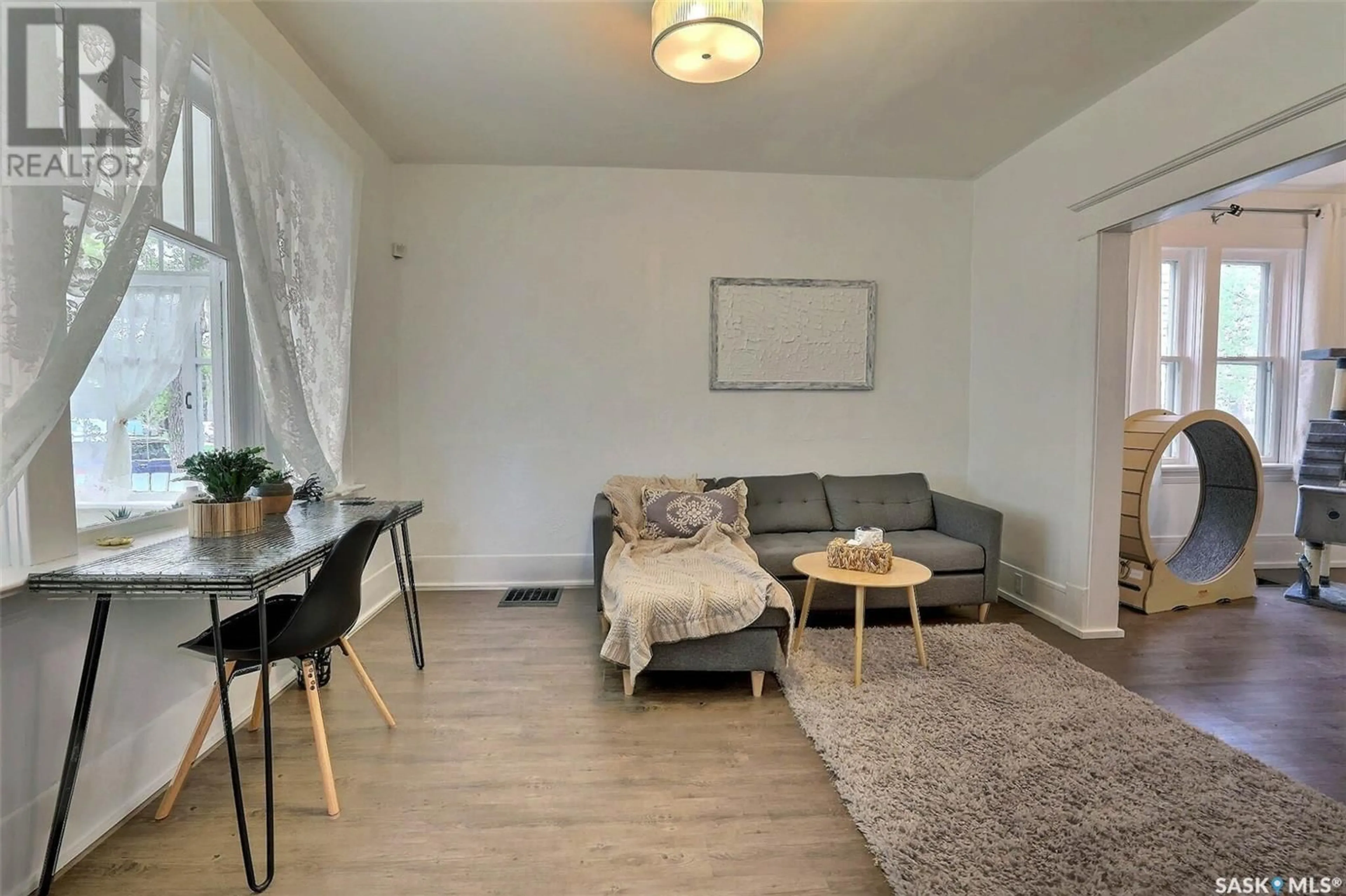 Living room with furniture, wood/laminate floor for 2824 12TH AVENUE, Regina Saskatchewan S4T1J4