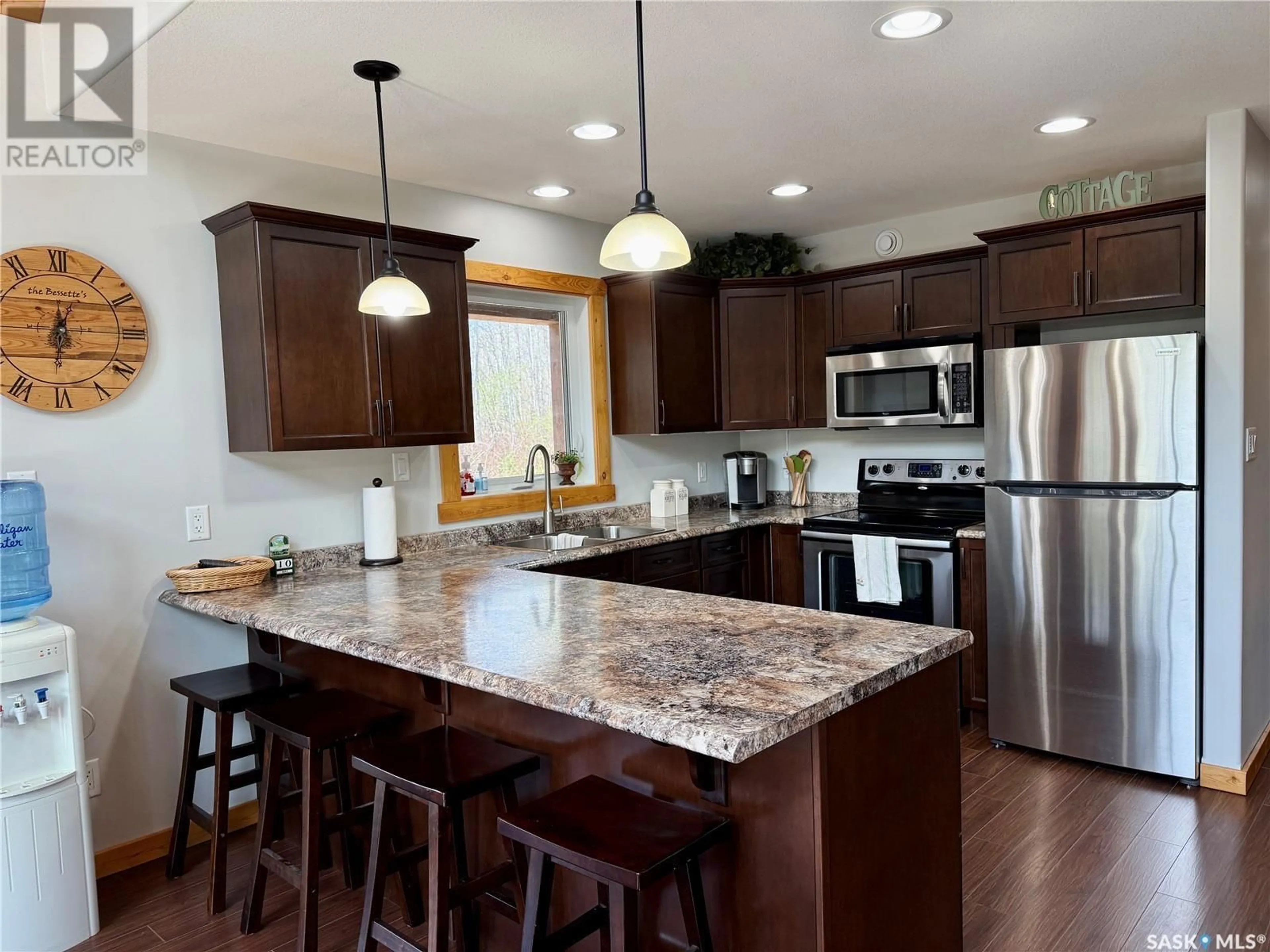 Open concept kitchen, wood/laminate floor for 114 PHILLIPS CRESCENT, Phillips Grove Saskatchewan S0J0E0