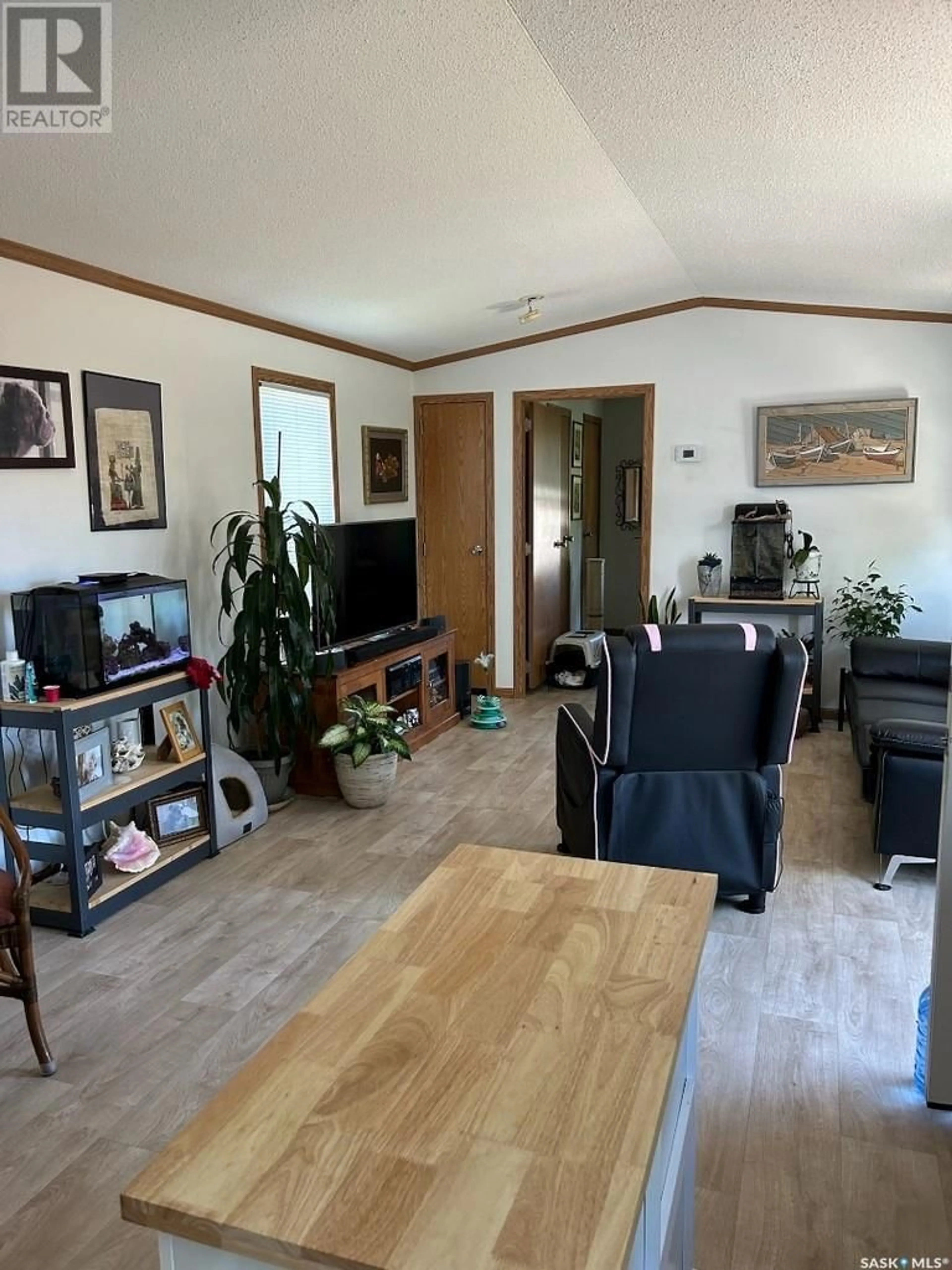 Living room with furniture, wood/laminate floor for 127 4TH STREET, Alameda Saskatchewan S0C0A0
