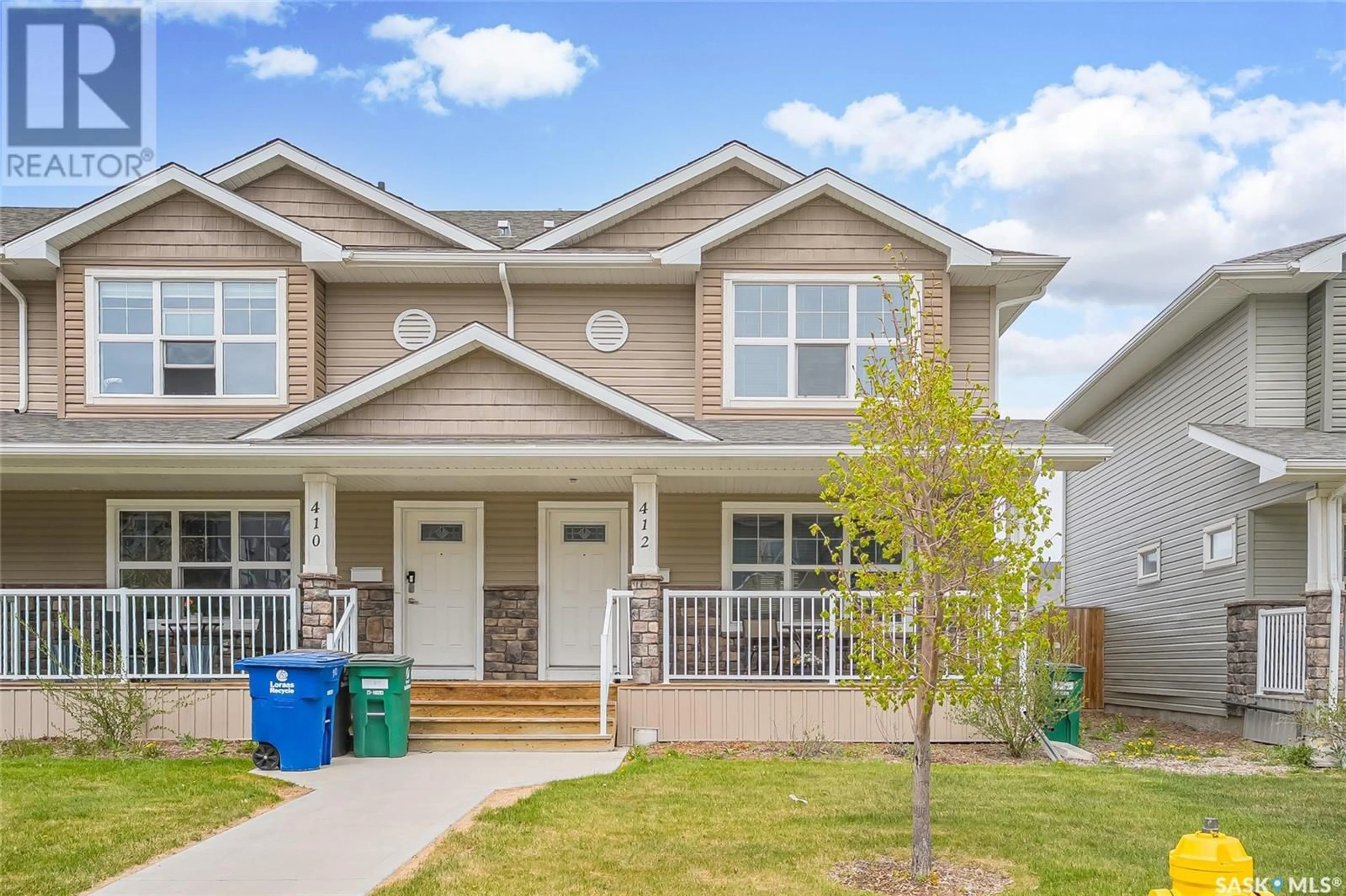Home with vinyl exterior material, street for 412 MANINGAS BEND, Saskatoon Saskatchewan S7W0V6