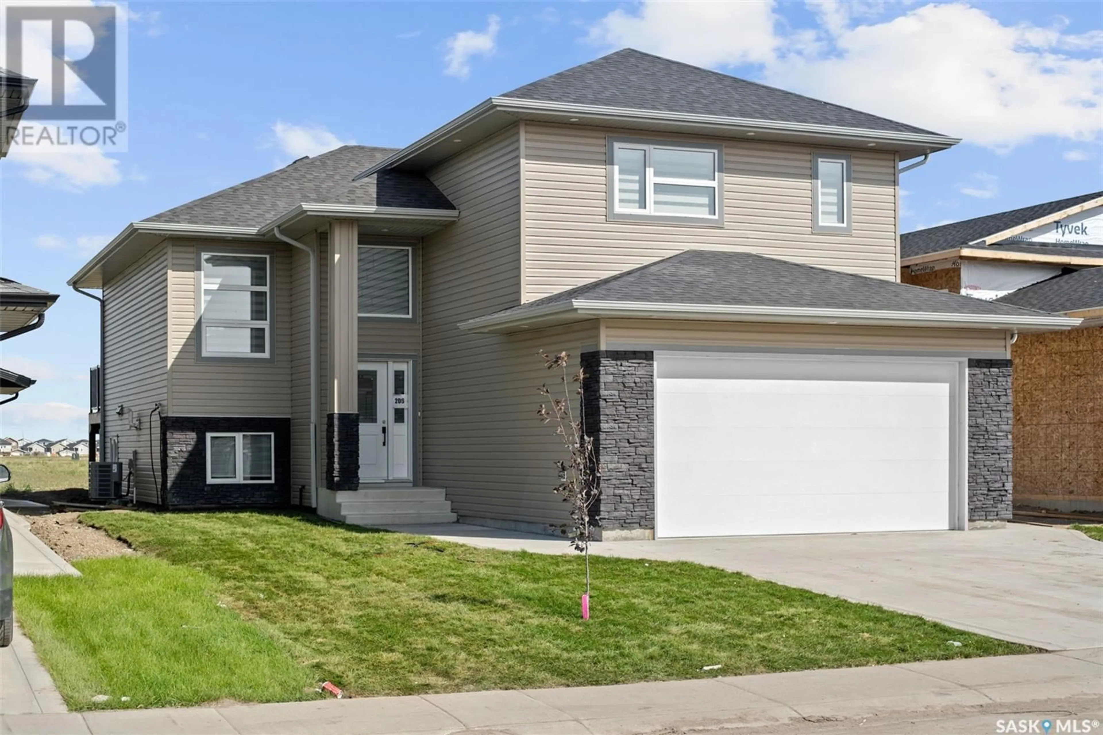 Home with vinyl exterior material, street for 222 SHARMA LANE, Saskatoon Saskatchewan S7W1K7