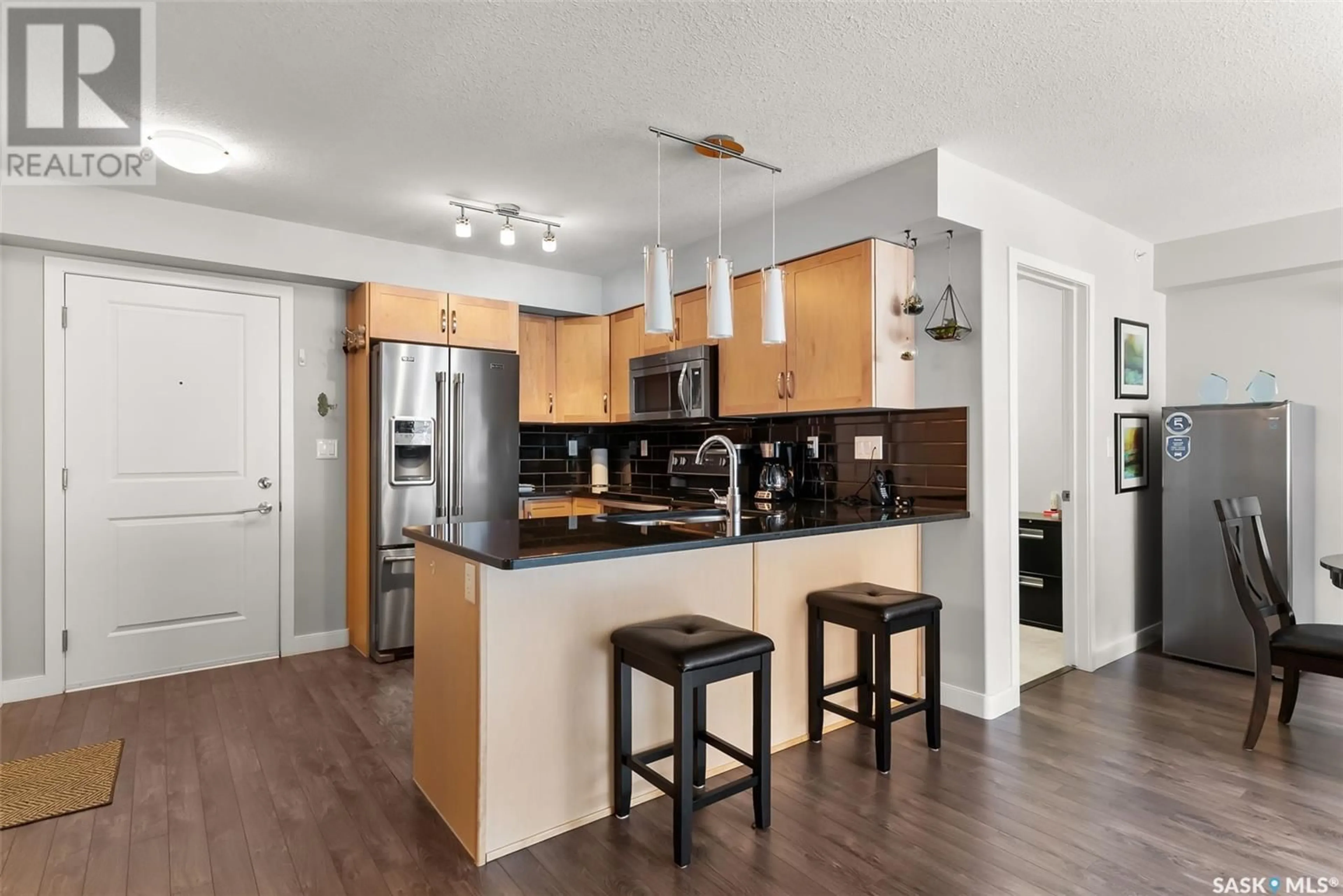 Open concept kitchen, wood/laminate floor for 307 - 2321 WINDSOR PARK ROAD, Regina Saskatchewan S4V3N2