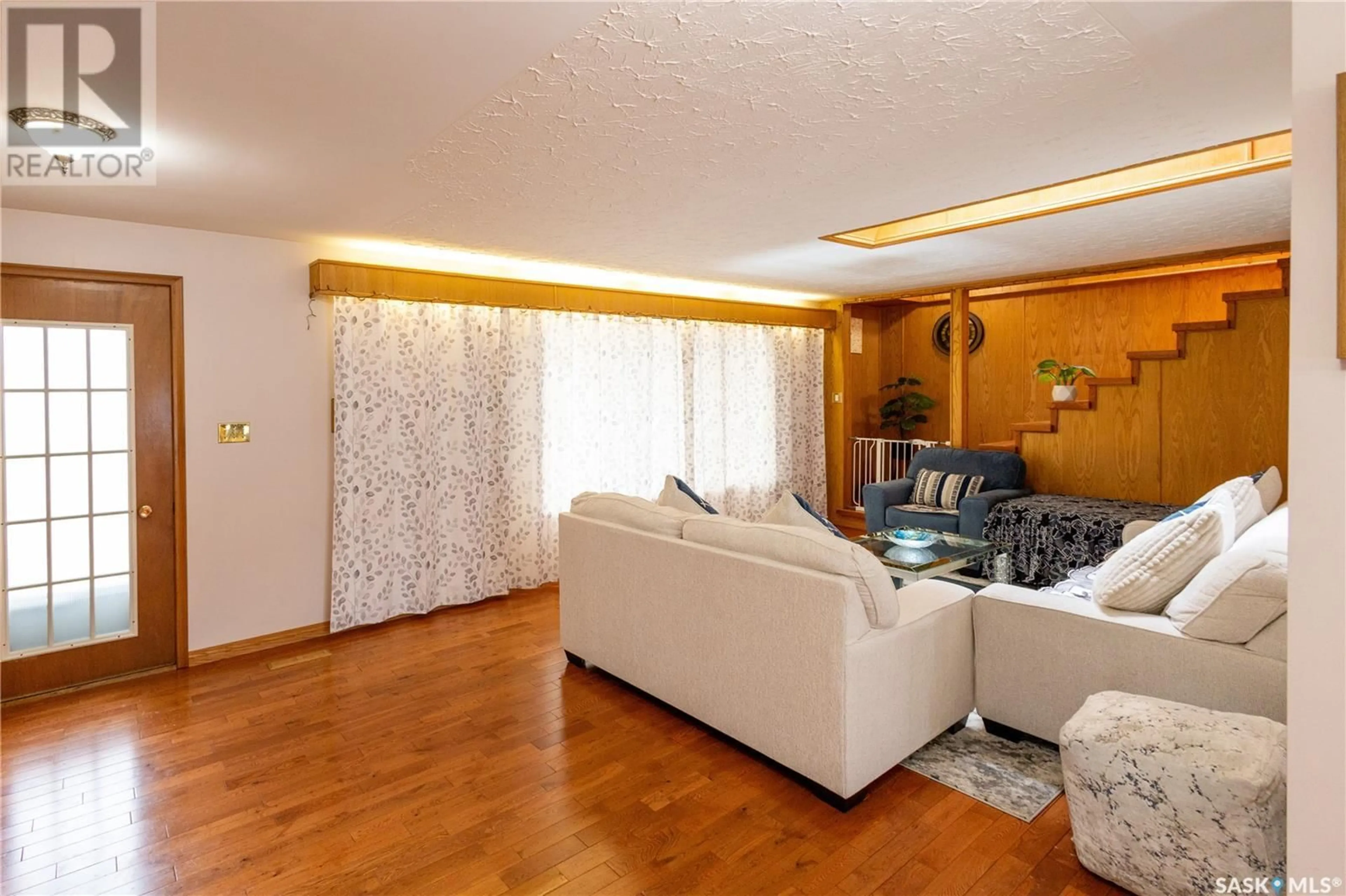 Living room with furniture, wood/laminate floor for 710 CUELENAERE STREET, Prince Albert Saskatchewan S6V2S9