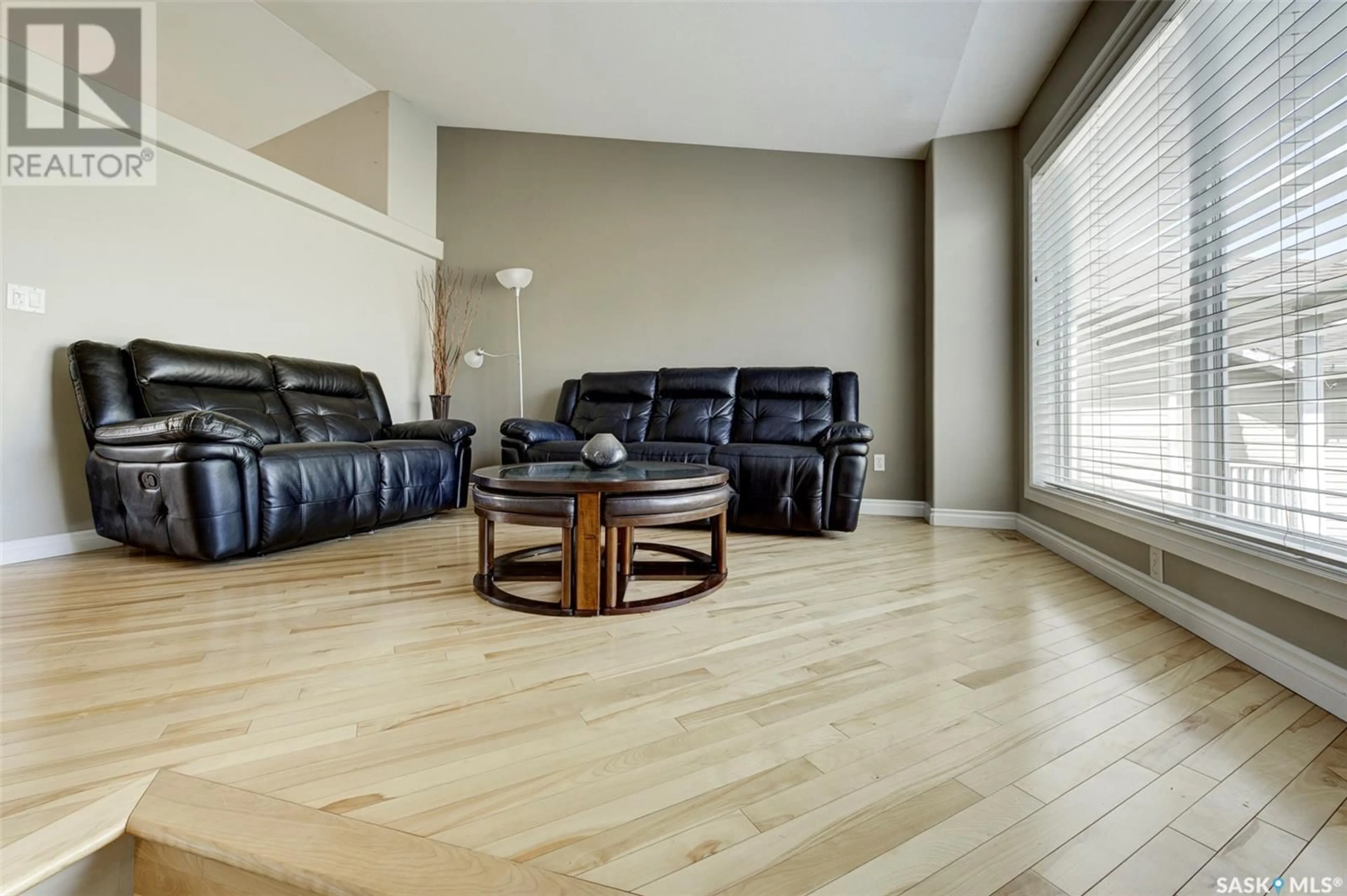 Living room with furniture, wood/laminate floor for 407 ADASKIN COVE, Saskatoon Saskatchewan S7N4P4