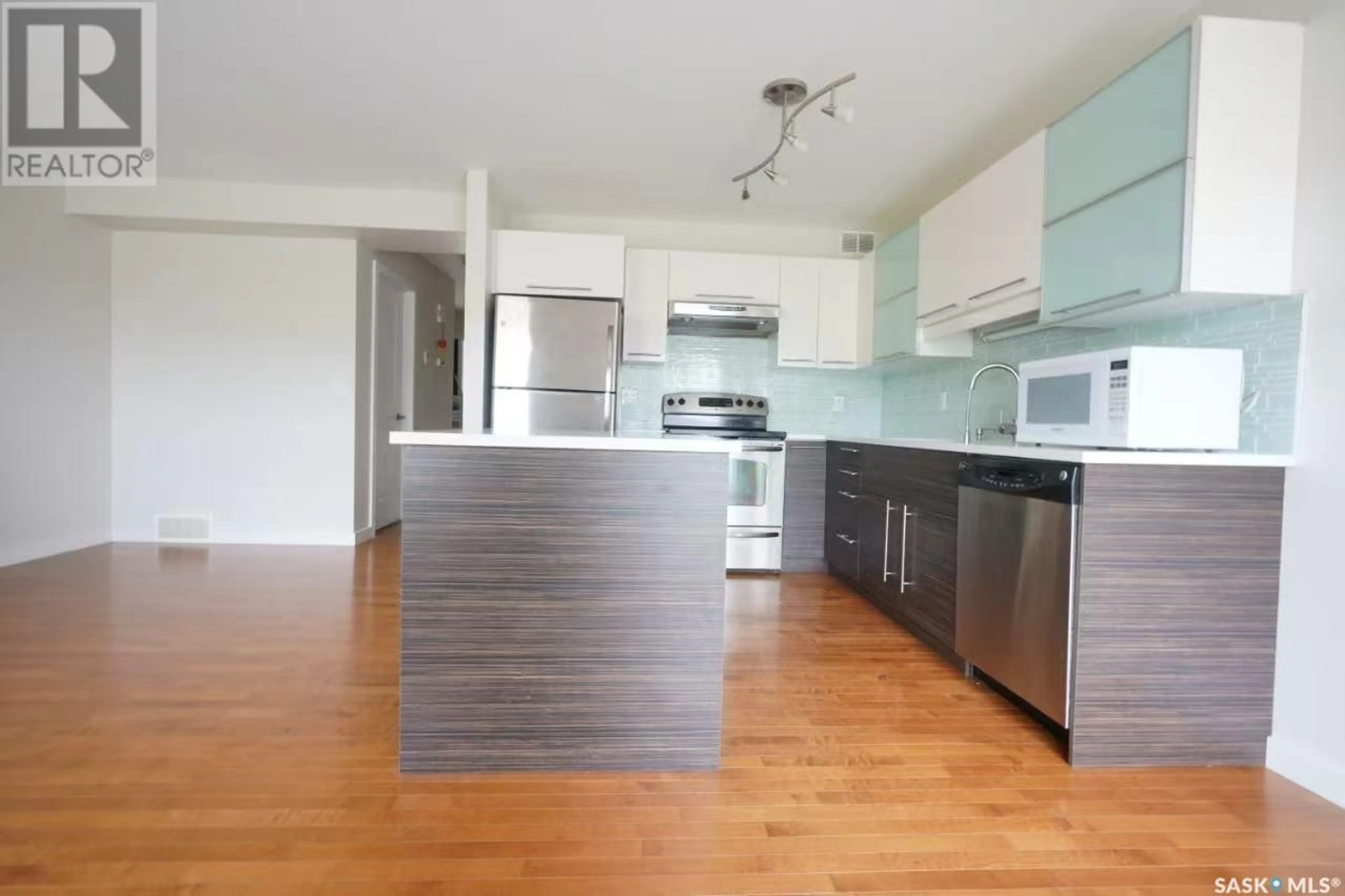 Open concept kitchen, wood/laminate floor for 307 - 710 GORDON ROAD, Saskatoon Saskatchewan S7T0J5