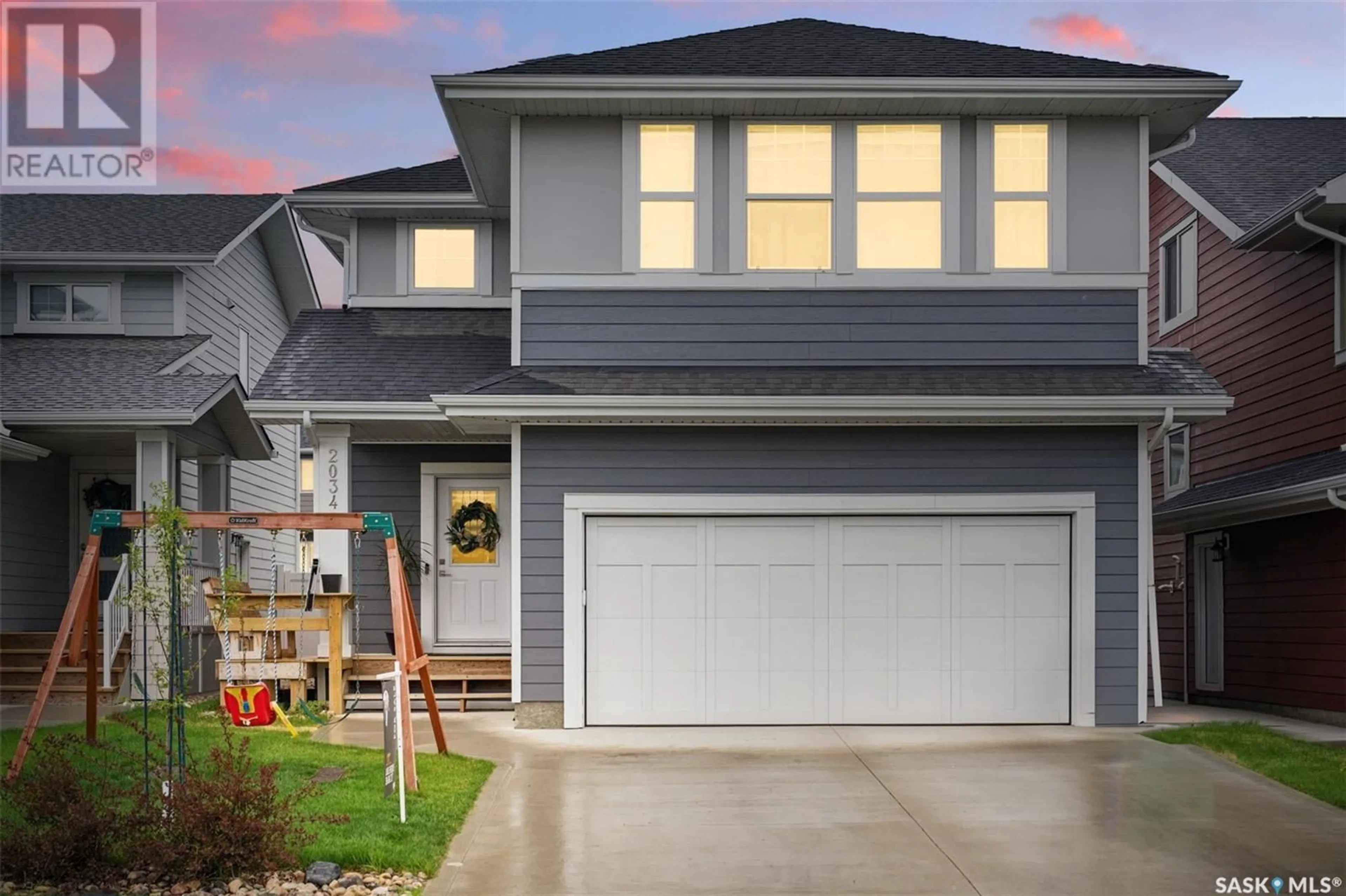 Home with vinyl exterior material, street for 2034 STILLING LANE, Saskatoon Saskatchewan S7V0X1