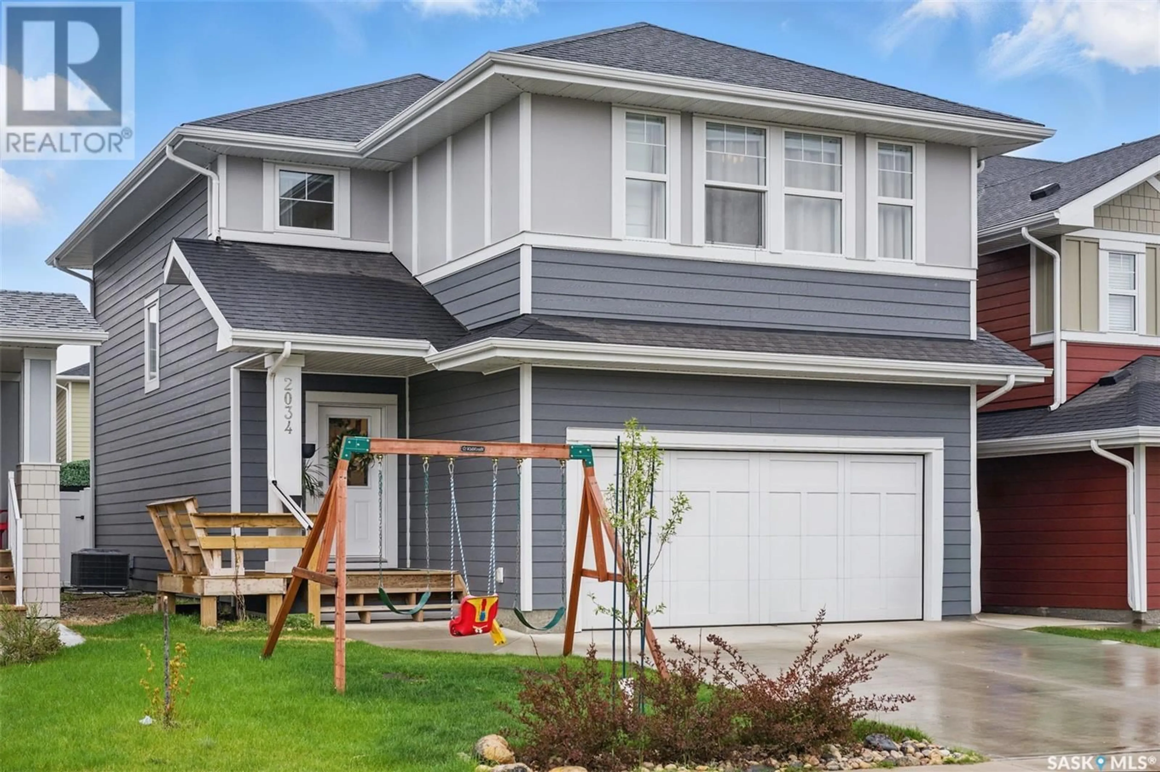 Home with vinyl exterior material, street for 2034 STILLING LANE, Saskatoon Saskatchewan S7V0X1