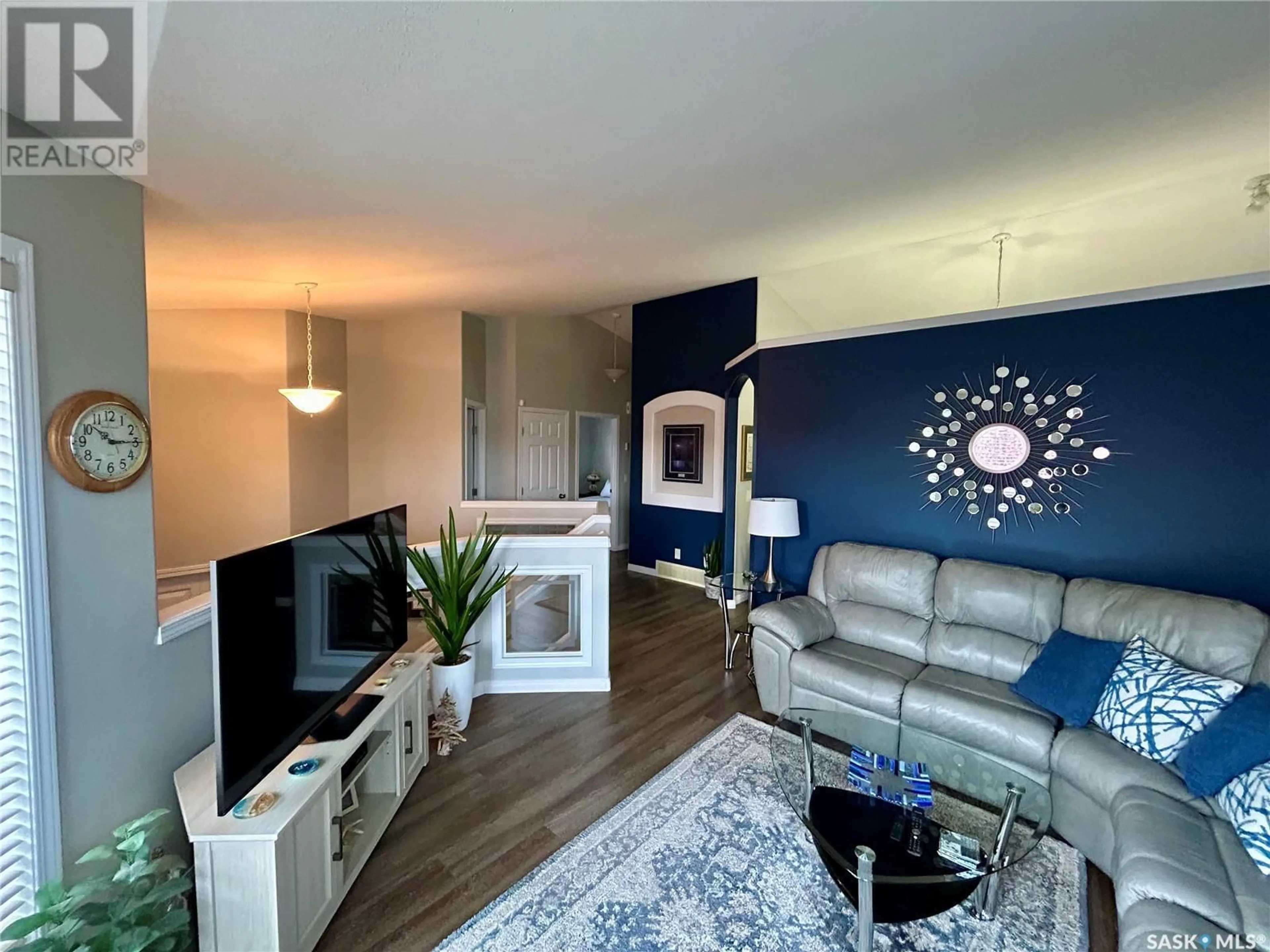 Living room with furniture, wood/laminate floor for 214 PETERS COVE, Saskatoon Saskatchewan S7N4T4