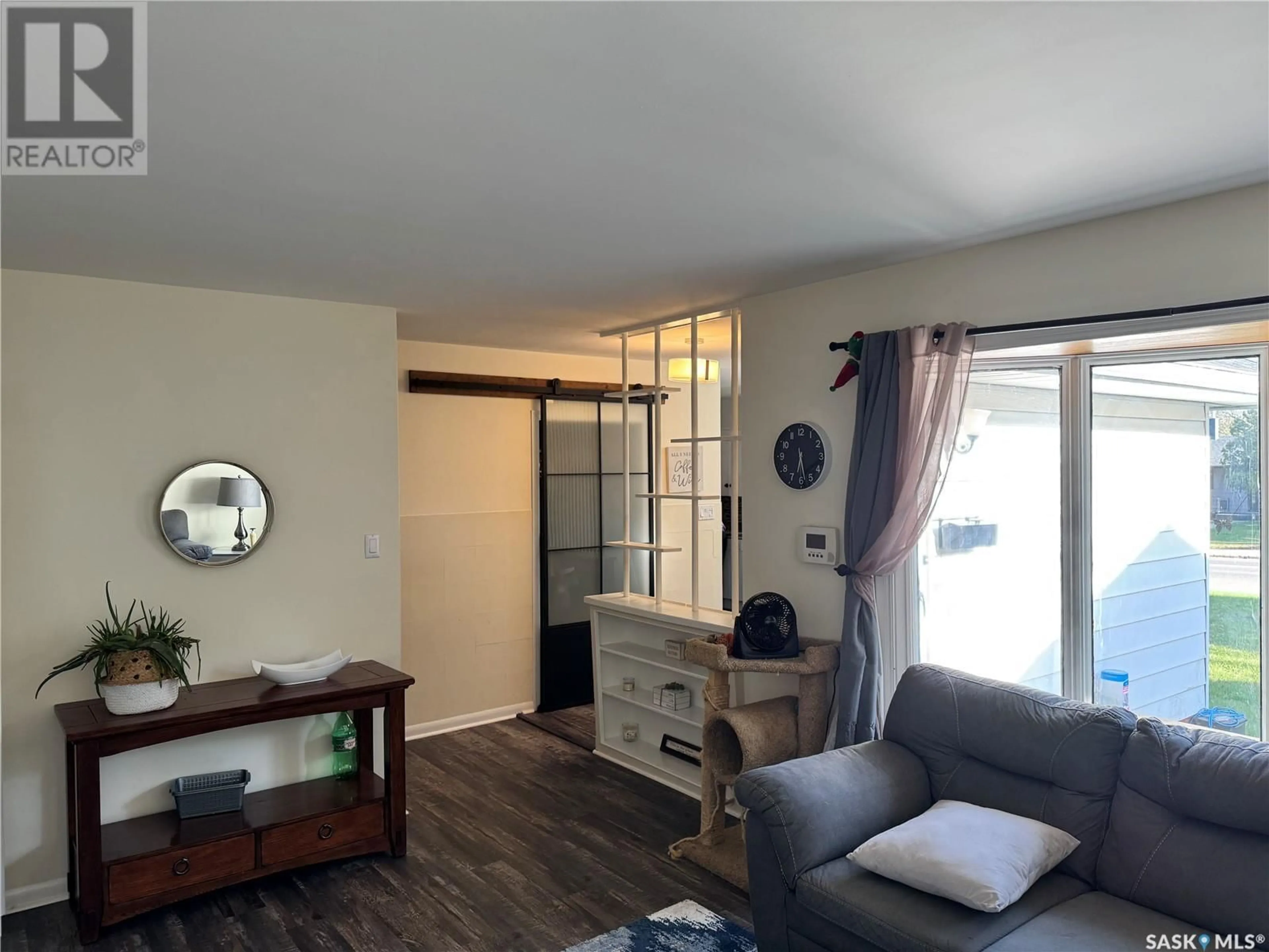 Living room with furniture, wood/laminate floor for 1310 33RD STREET, Saskatoon Saskatchewan S7L0W9
