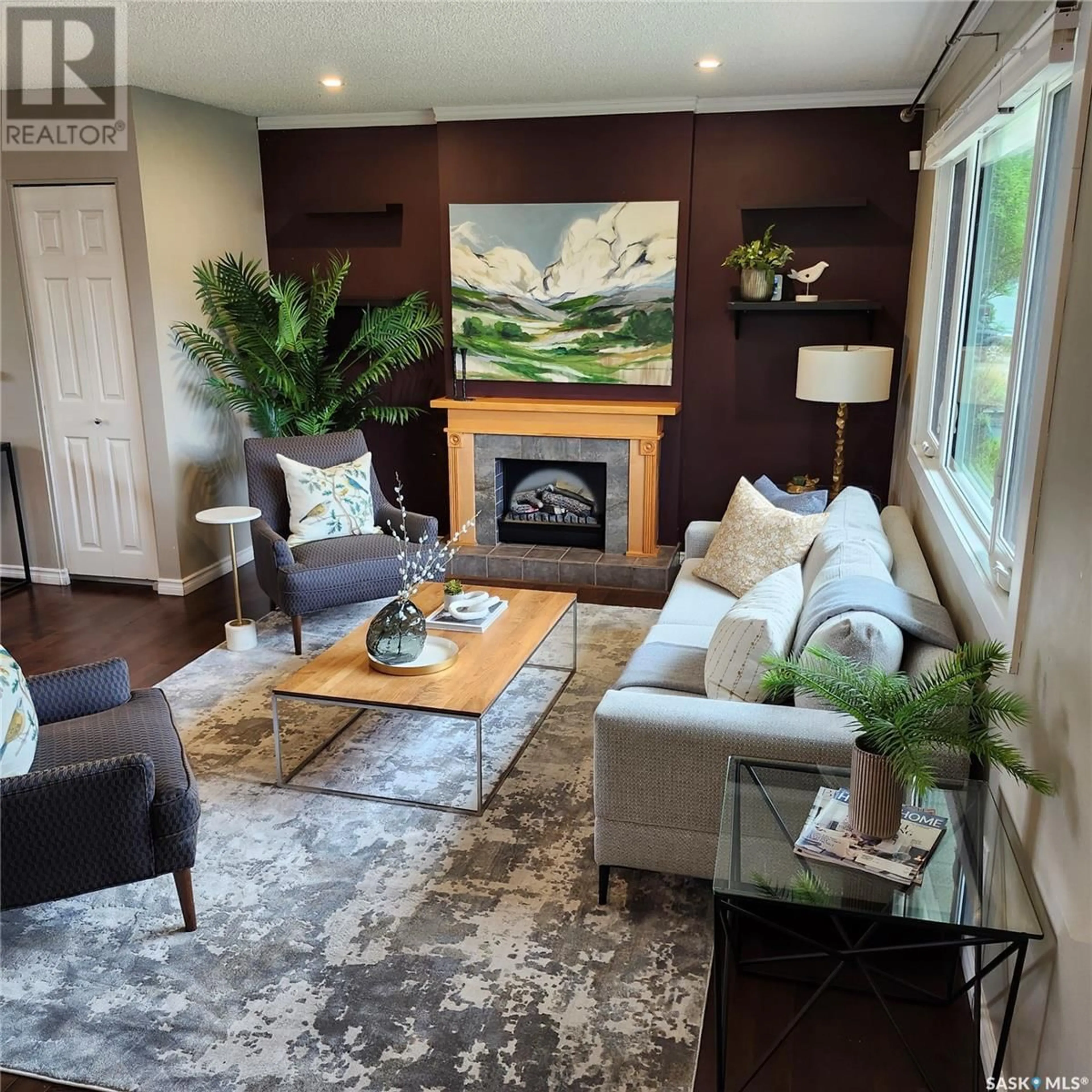 Living room with furniture, wood/laminate floor for 241 GUELPH CRESCENT, Saskatoon Saskatchewan S7H4P9