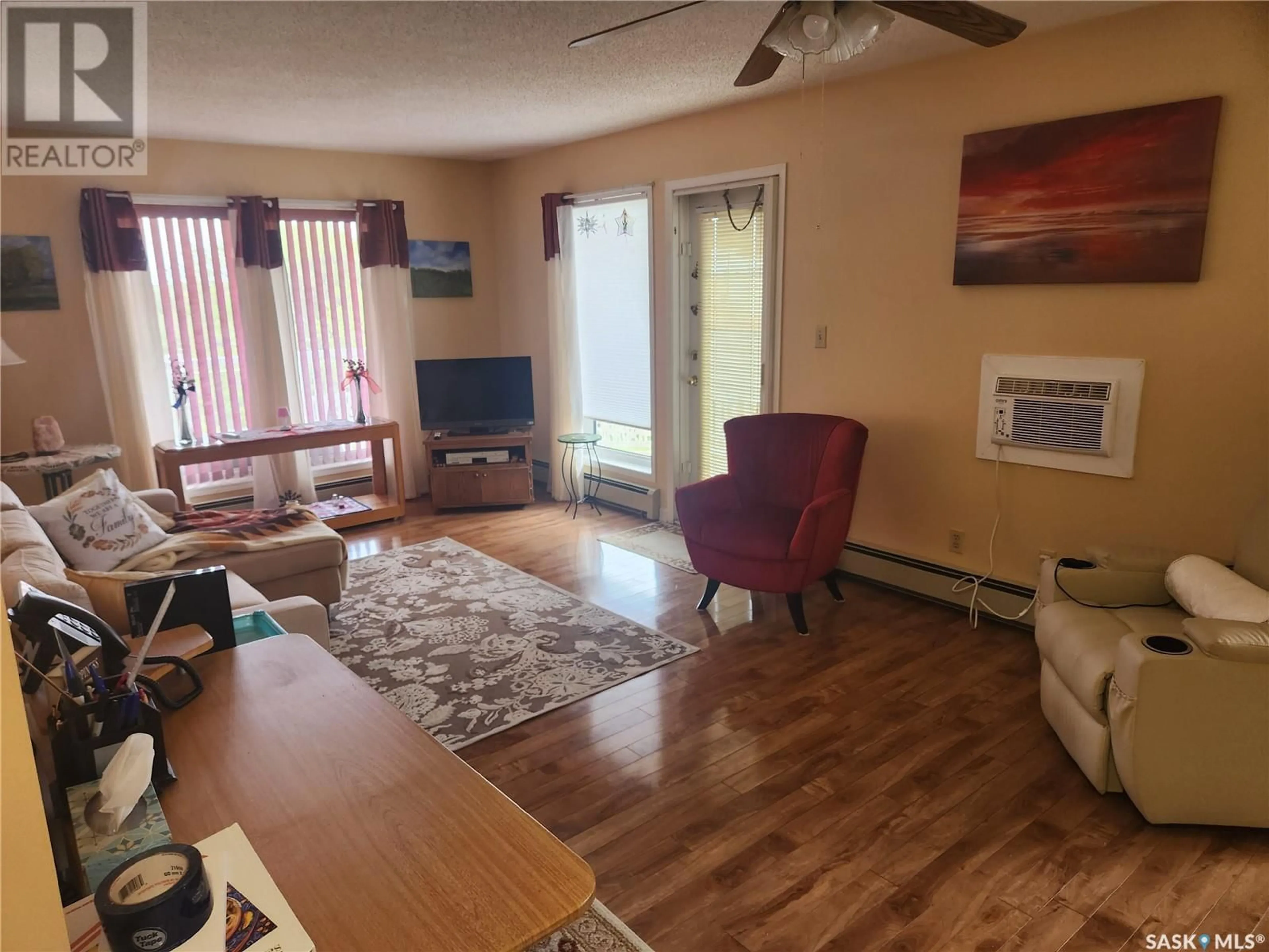 Living room with furniture, wood/laminate floor for 304 - 100A 100 STREET, Tisdale Saskatchewan S0E1T0