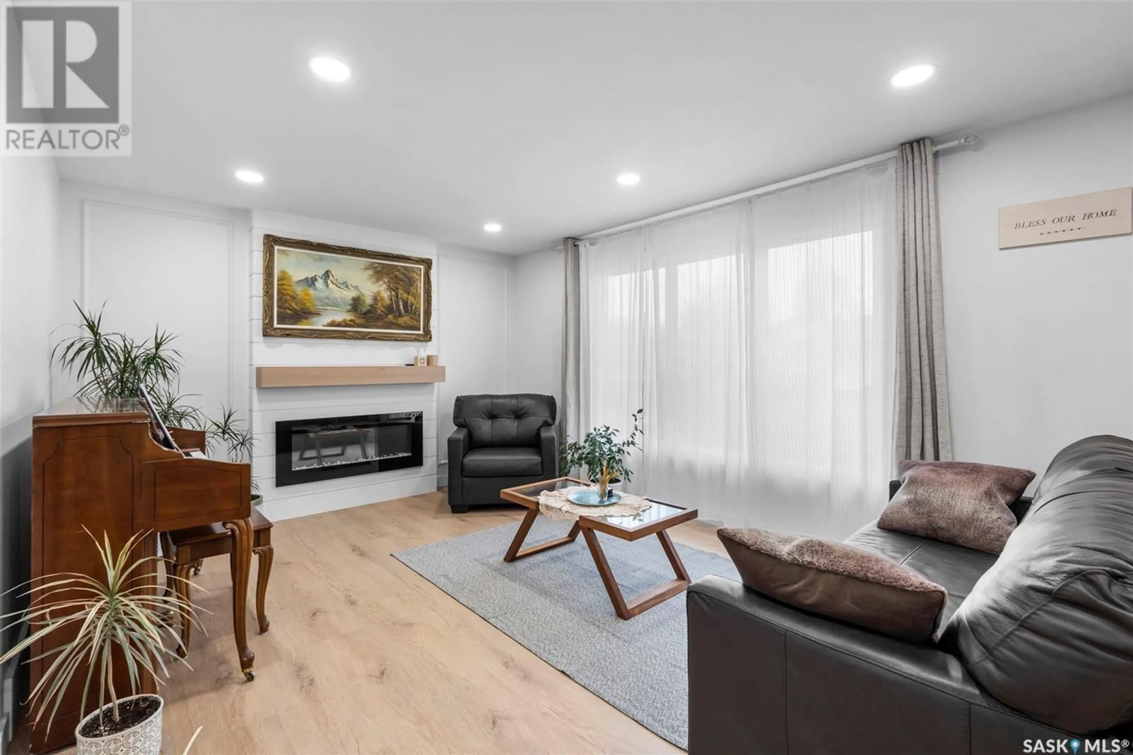 Living room with furniture, wood/laminate floor for 69 CHURCHILL DRIVE, Saskatoon Saskatchewan S7K3X2