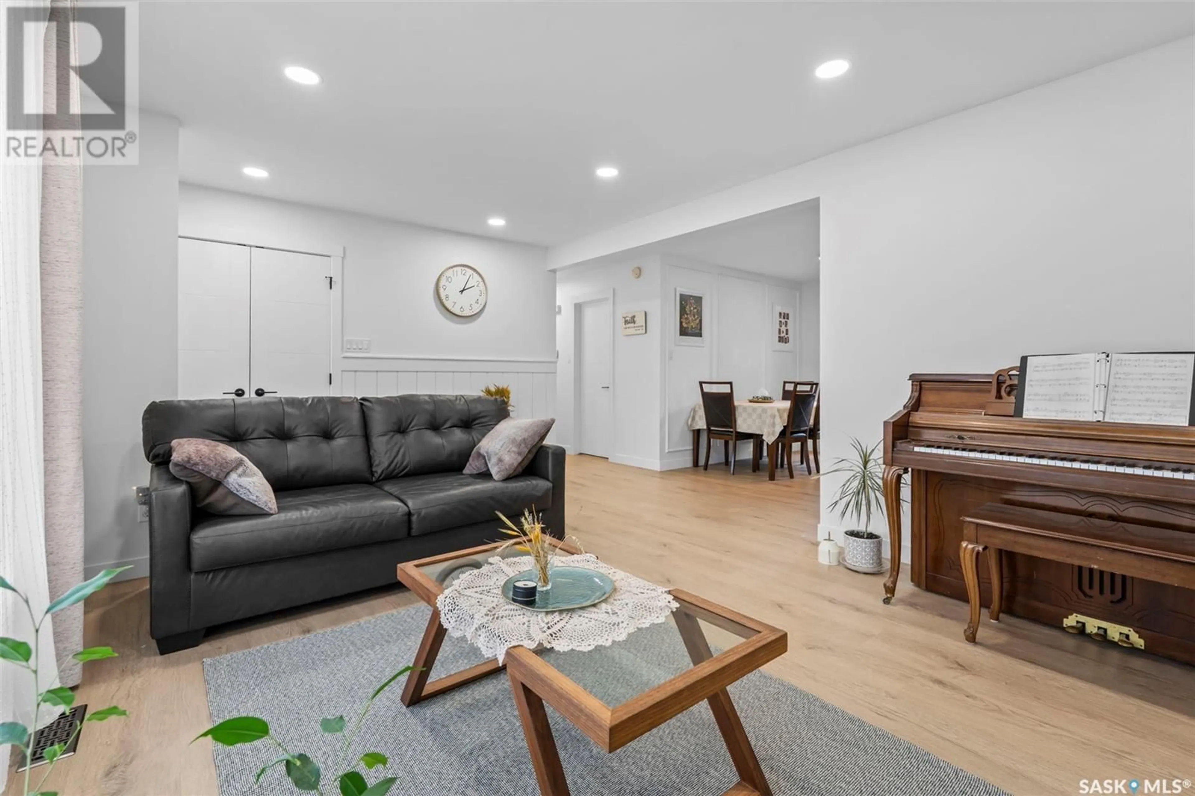 Living room with furniture, wood/laminate floor for 69 CHURCHILL DRIVE, Saskatoon Saskatchewan S7K3X2