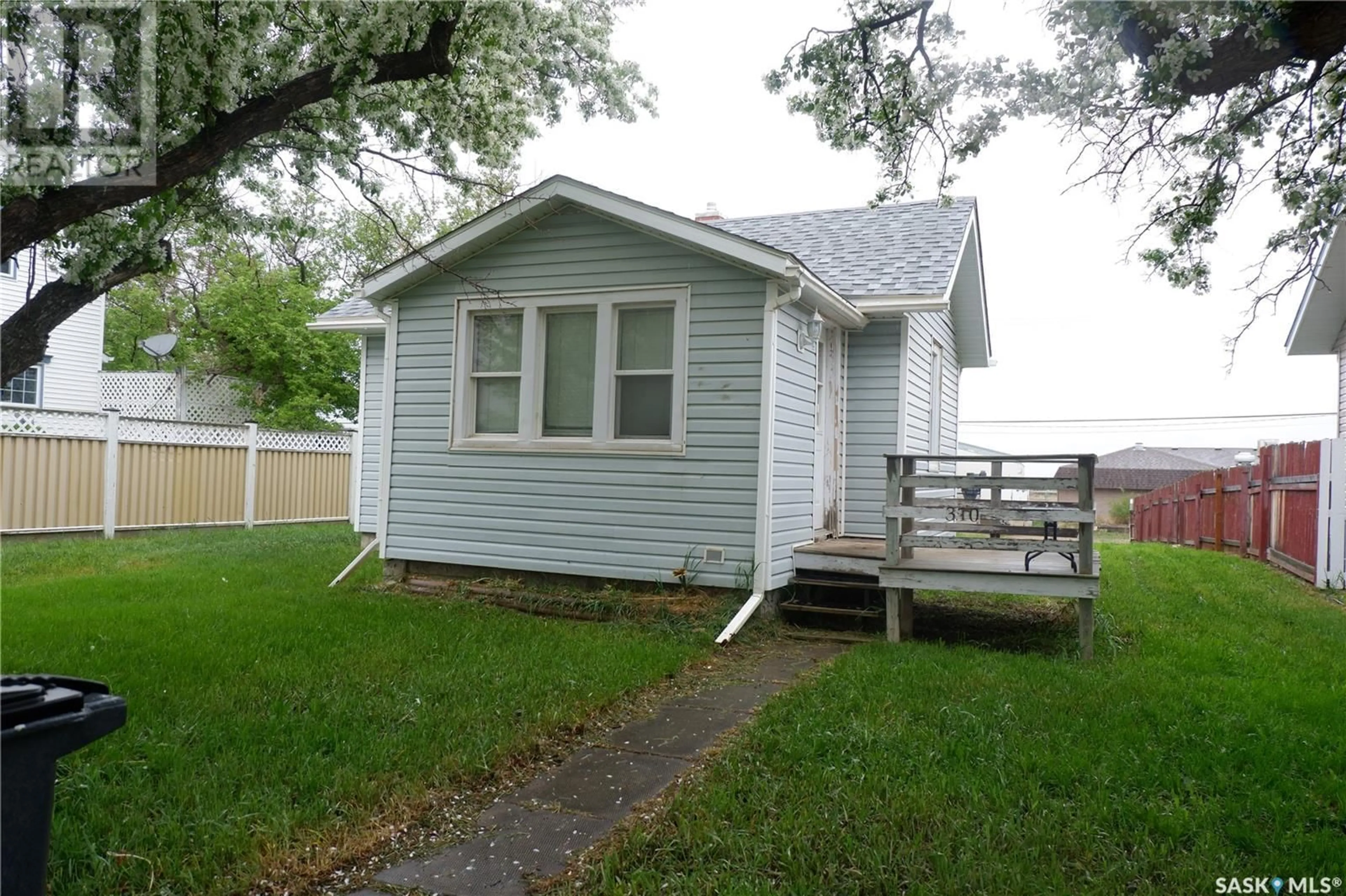 Home with vinyl exterior material, street for 310 2ND AVENUE, Assiniboia Saskatchewan S0H0B0