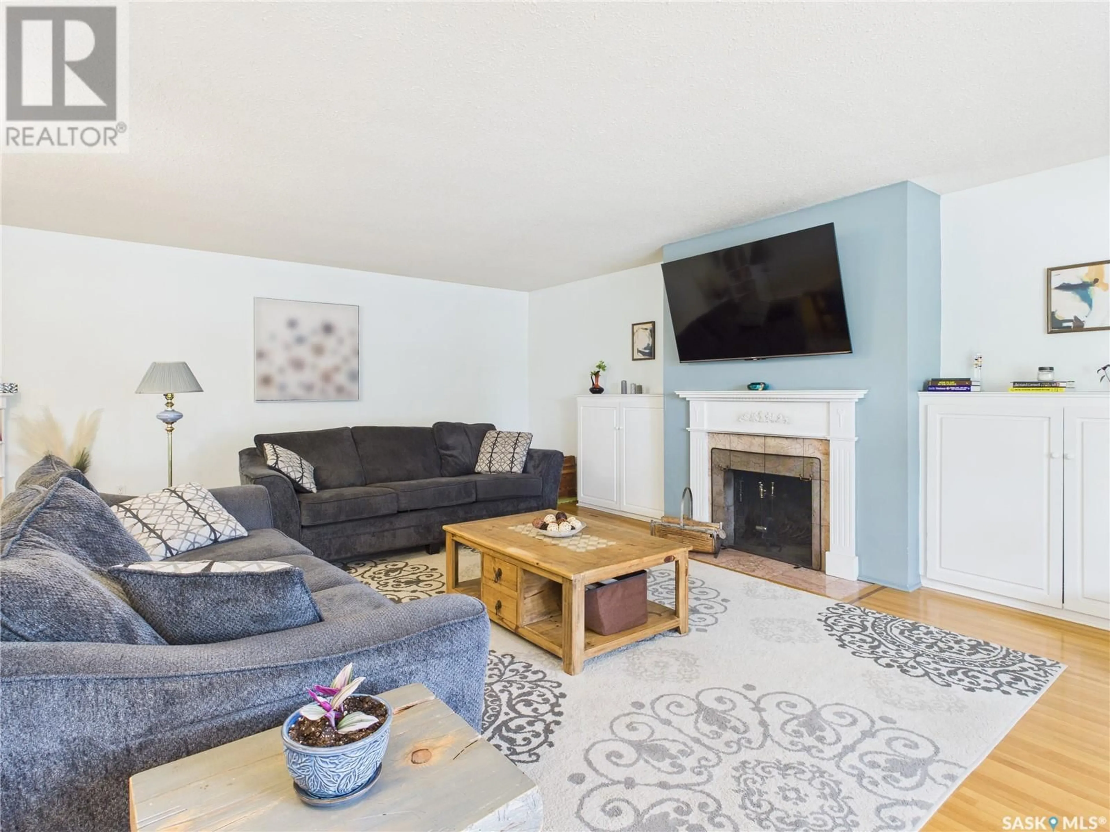 Living room with furniture, wood/laminate floor for 427 21ST STREET, Prince Albert Saskatchewan S6V4J5