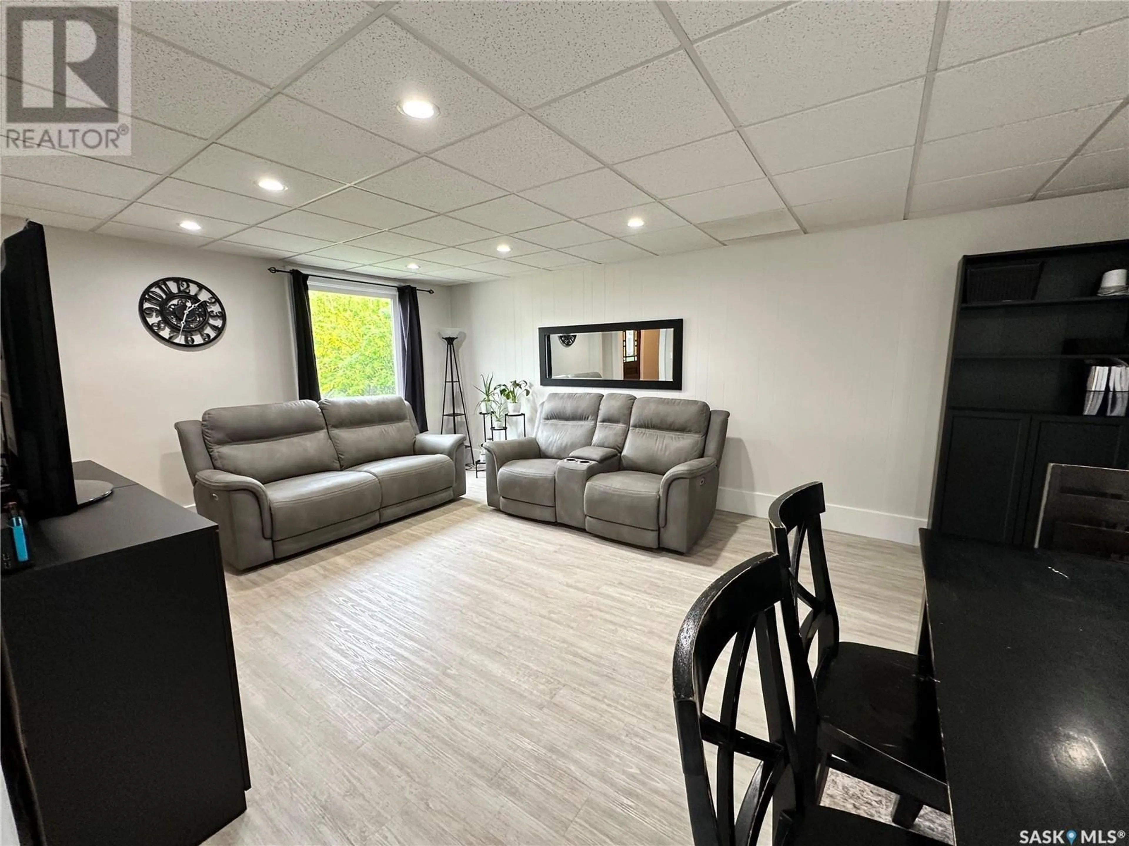 Living room with furniture, wood/laminate floor for 49 9TH AVENUE, Swift Current Saskatchewan S9H2R9