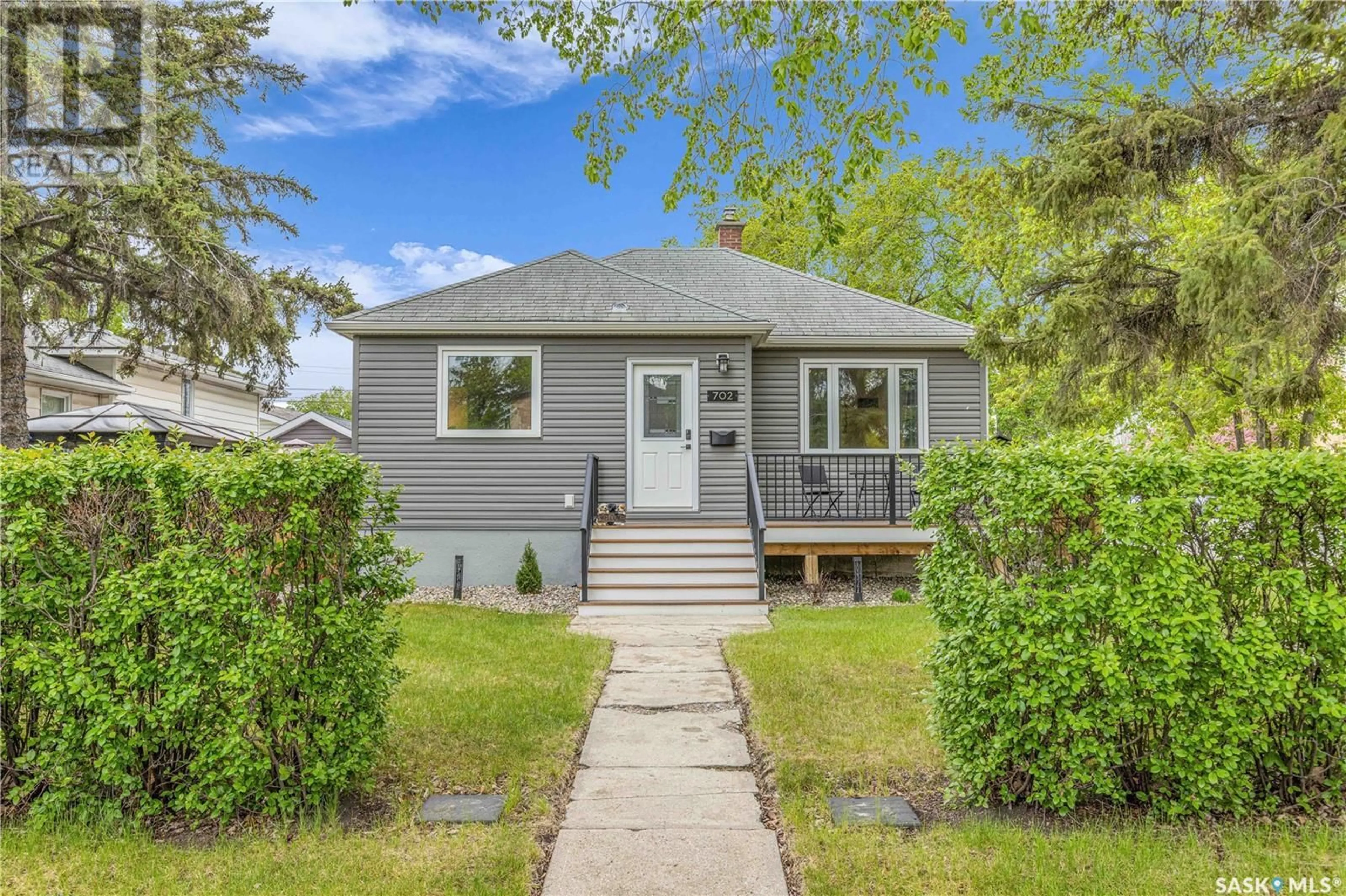 Home with vinyl exterior material, street for 702 1ST STREET, Saskatoon Saskatchewan S7H1T1