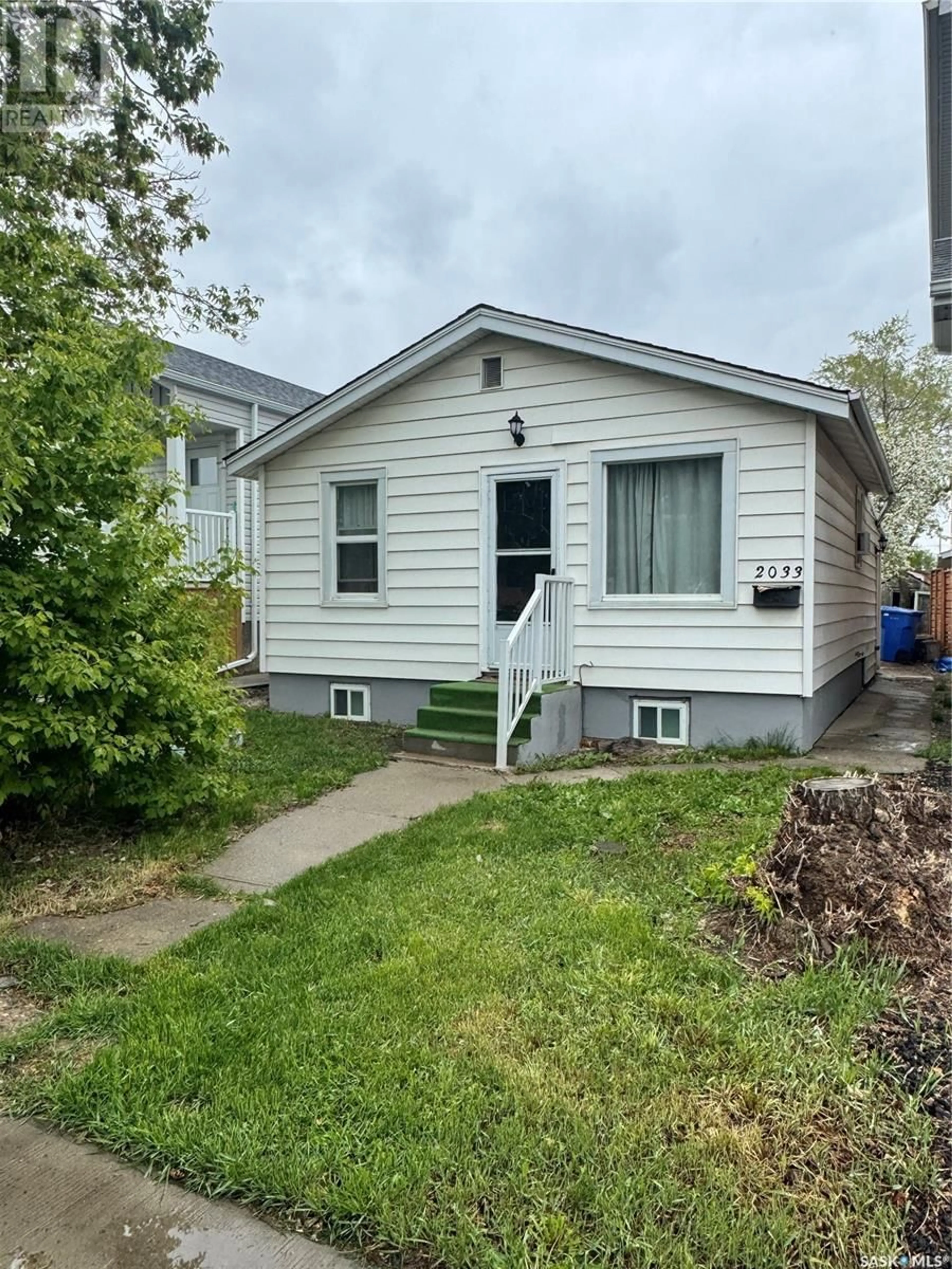Home with vinyl exterior material, street for 2033 FRANCIS STREET, Regina Saskatchewan S4N2P2