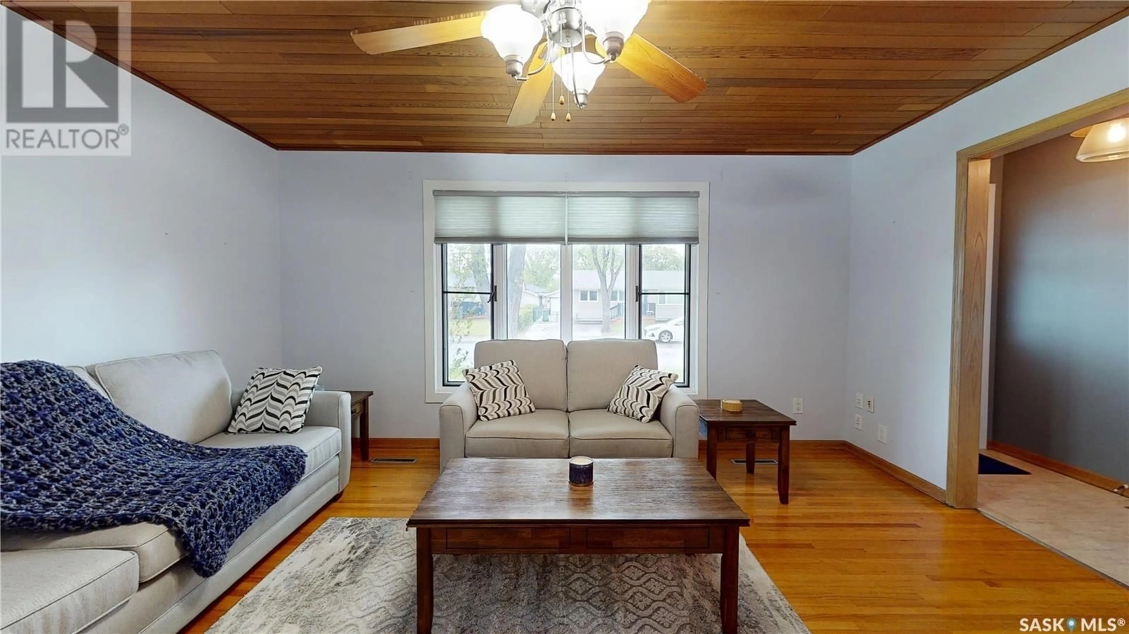 Living room with furniture, wood/laminate floor for 44 GALE STREET, Regina Saskatchewan S4R4E1