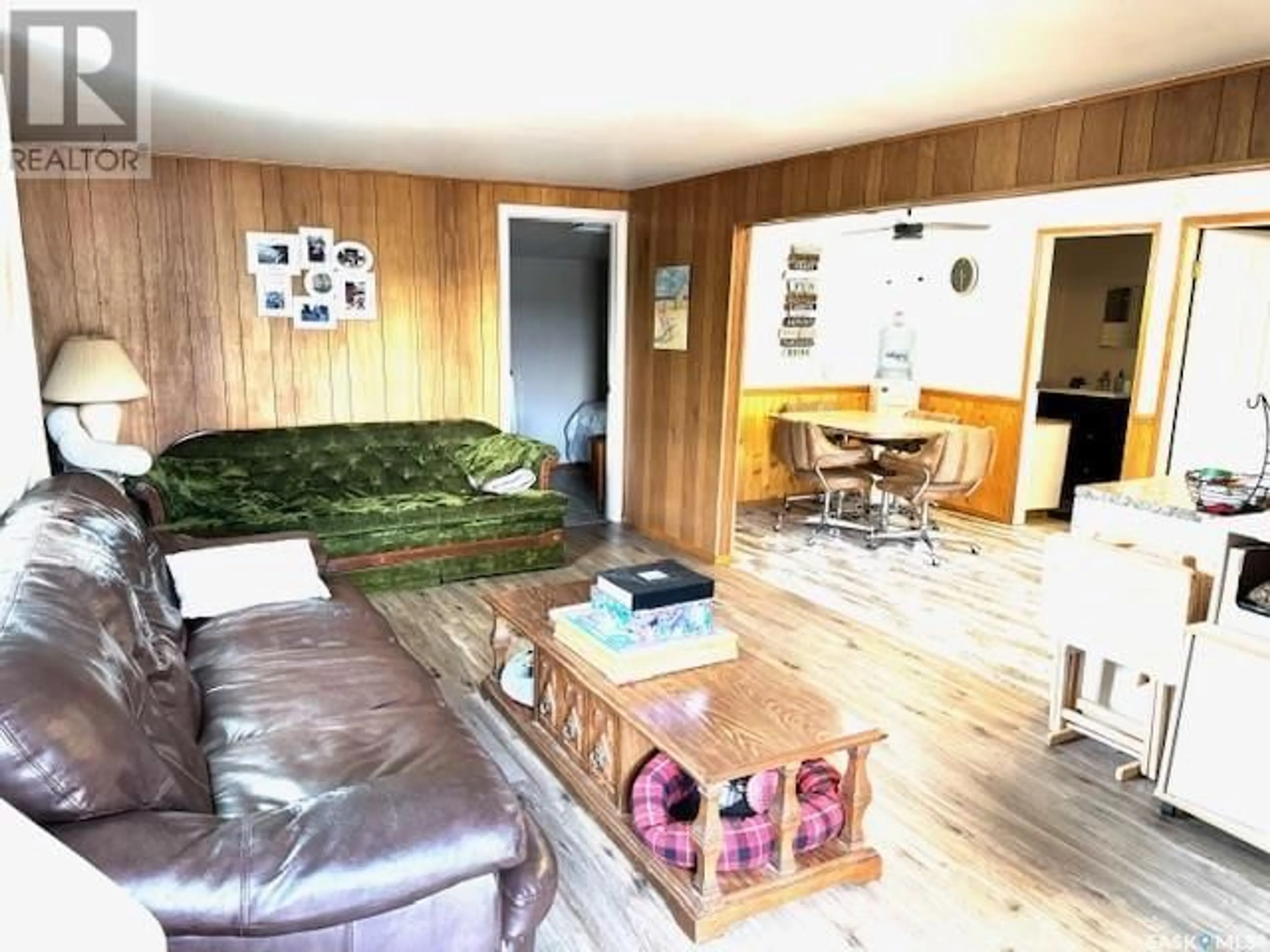 Living room with furniture, wood/laminate floor for 9031 HUNTS COVE CRESCENT, Cochin Saskatchewan S0M0L0